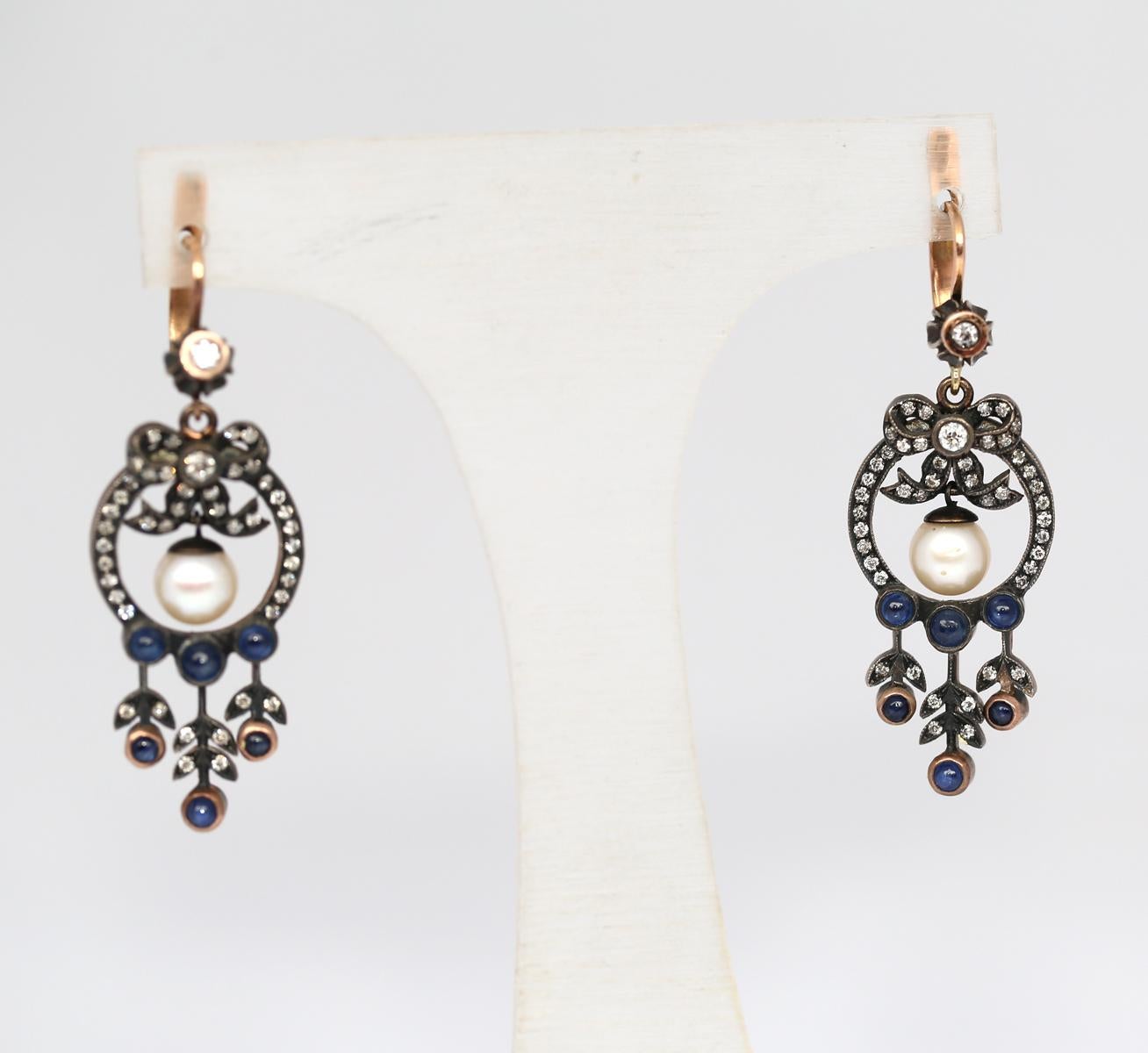 Victorian Style Chandelier Earrings Pearls and Cabochon Sapphires. 

Fine, masterful handcrafted execution. Each earring consists of three parts. All the parts of the earring are moving with the motion of the head. Really fine and delicate earrings