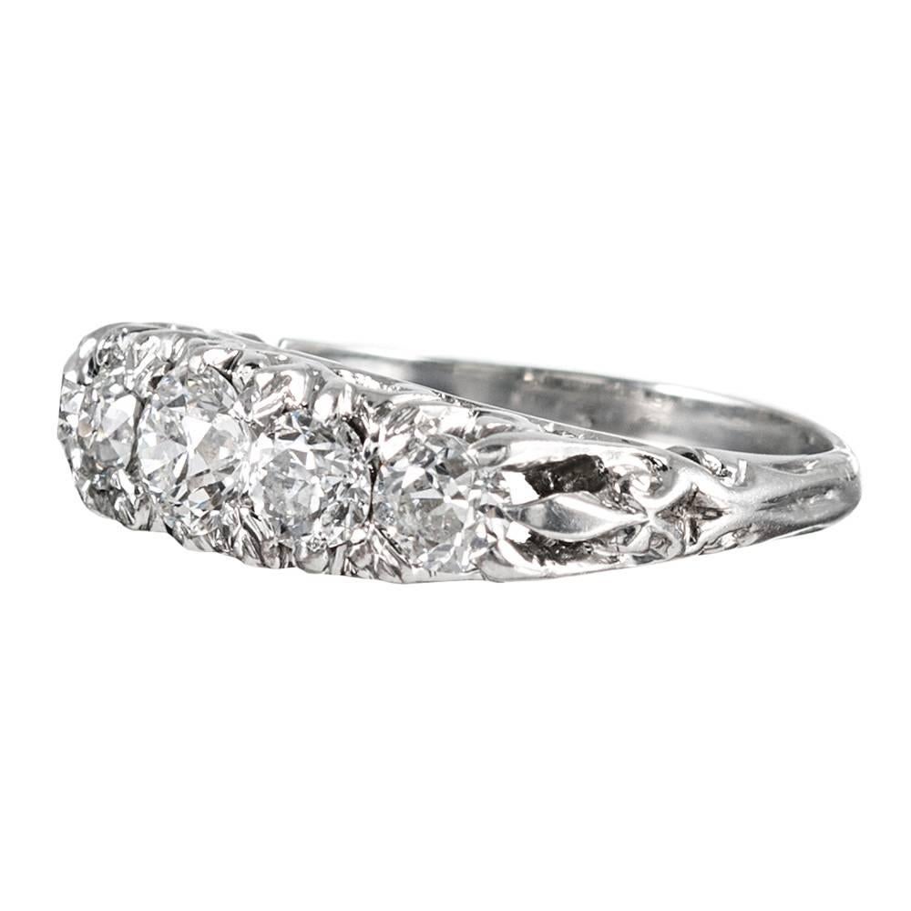 Created in the classic Victorian “English Carved” style, yet of later manufacture, this five stone ring is set with a single row of old European brilliant cut diamonds. The stones weigh 1.00 carat in total. This ring can be worn alone or stacked