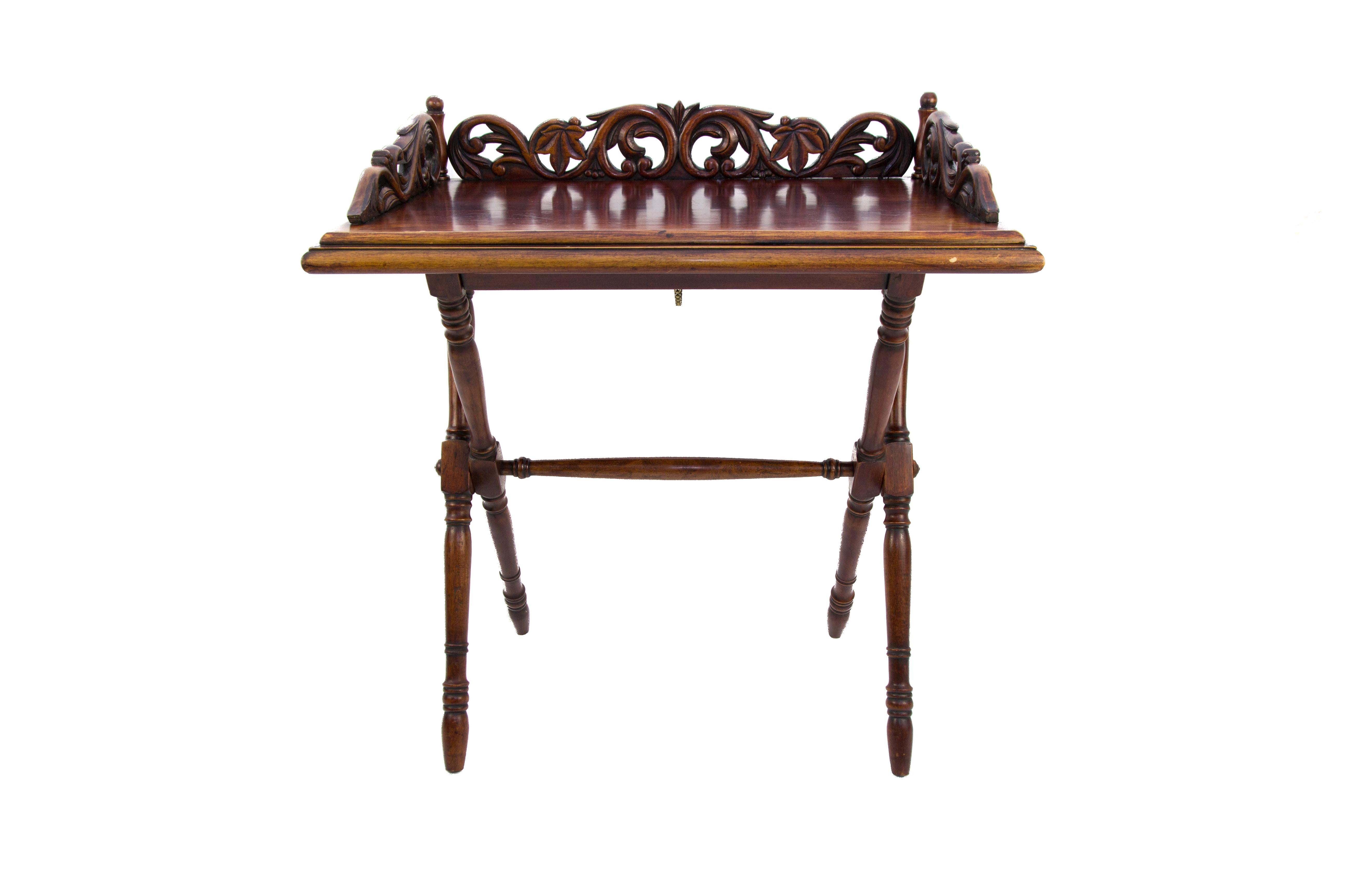 An ornate and elegant Victorian-style folding table with carvings, made of walnut, France, circa the 1920s.
In good antique condition, with slight age-related signs of wear.
Dimensions: height 74 cm / 29.1 in; width 67 cm / 26.3 in; depth 43 cm / 17