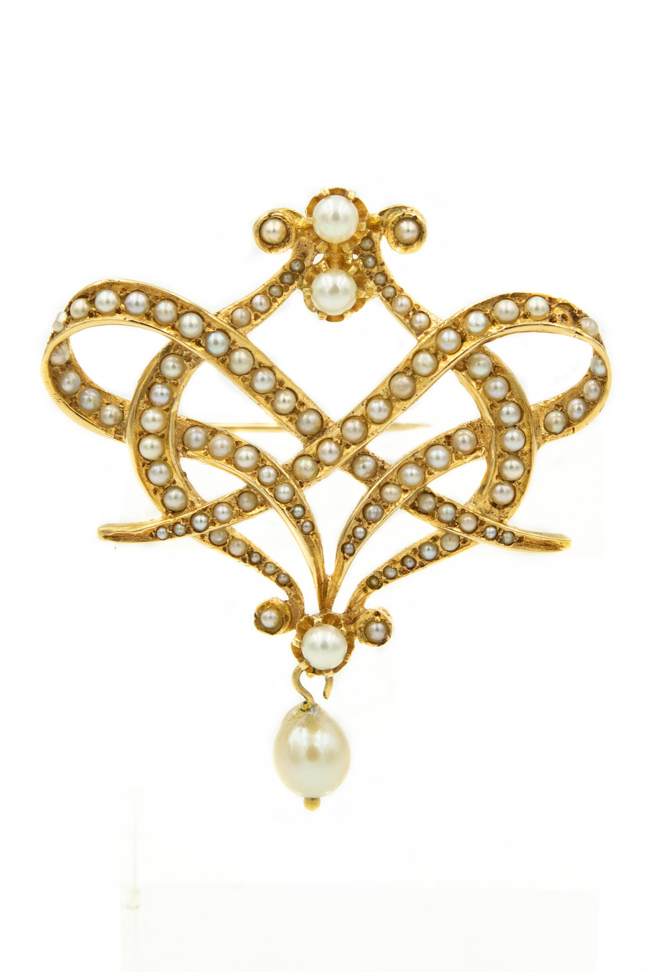 1970s Victorian style seed pearl garland ribbon design brooch with cultured pearl drop.  The back also has pendant double loop for a necklace to go through.

Matching 14k yellow gold earrings have cultured pearls dropping from seed pearl shields. 