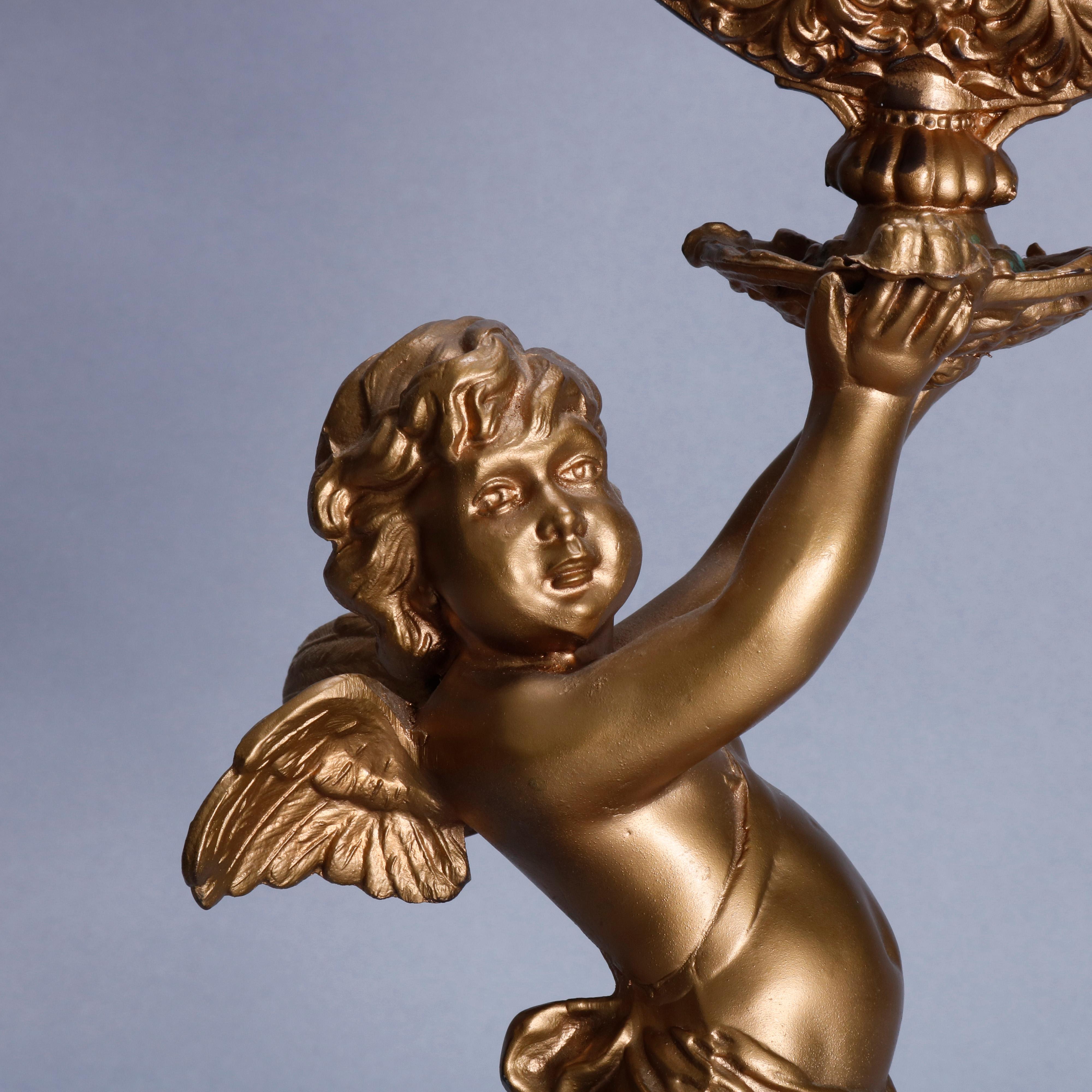 A Victorian style figural mantel clock offers gilt metal case with Classical cherub, raised on pierced base, en verso Pat Sep22 85, 20th century.

Measures: 20.5