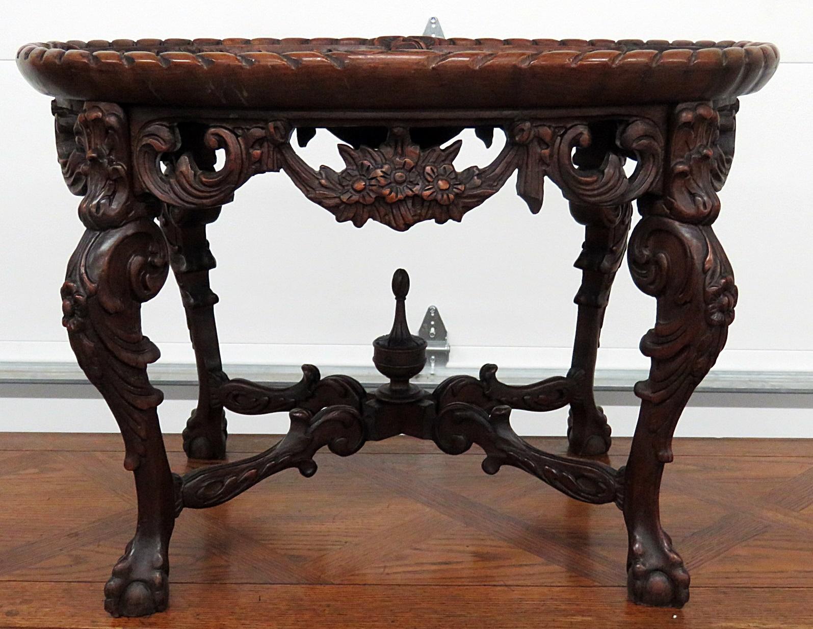 Victorian style inlaid glass top coffee table with beveled glass and ball and claw feet.