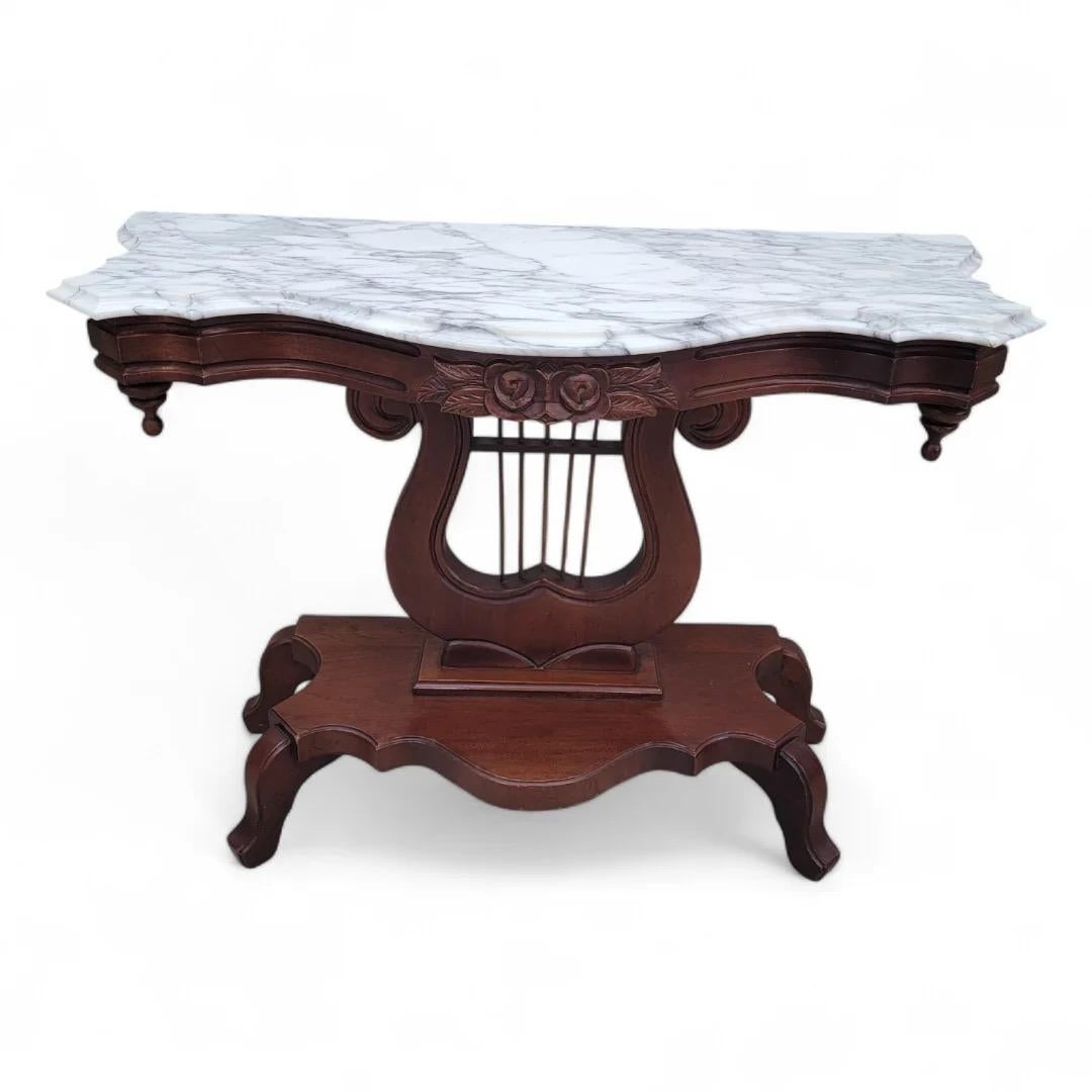 Victorian Style J.B. Van Sciver Marble Top Mahogany Harp Lyre Console Table

Ideal for displaying decorative items or as a functional surface in entryways or living spaces, this console table combines beauty and utility seamlessly.

