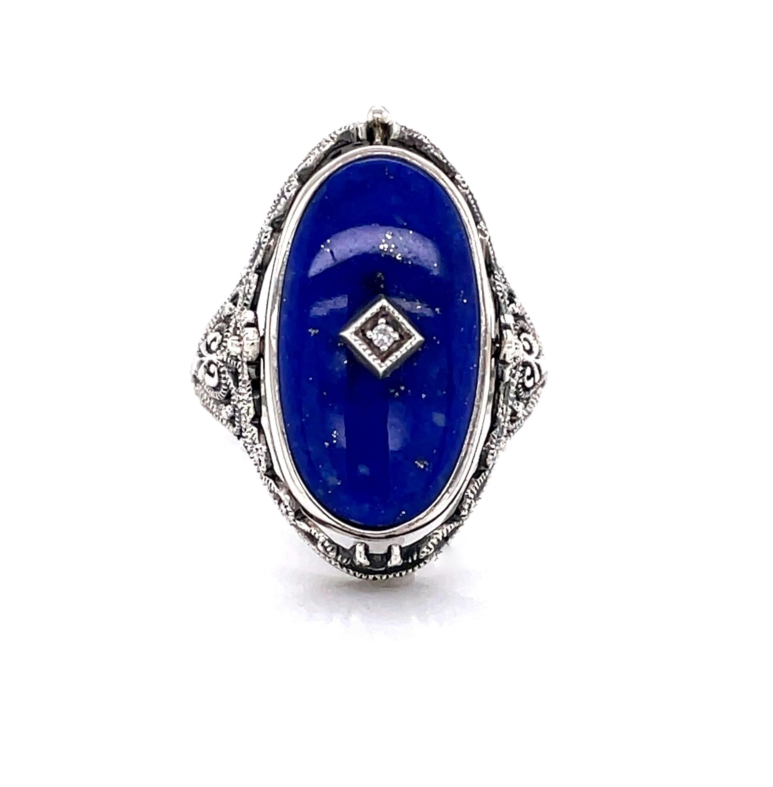 Polished vivid blue natural lapis highlighted with a diamond accent is the bold face of this Victorian Style sterling silver oval flip ring. With a flip of the head, a glossy black onyx stone can be display. Crafted of toned sterling silver with