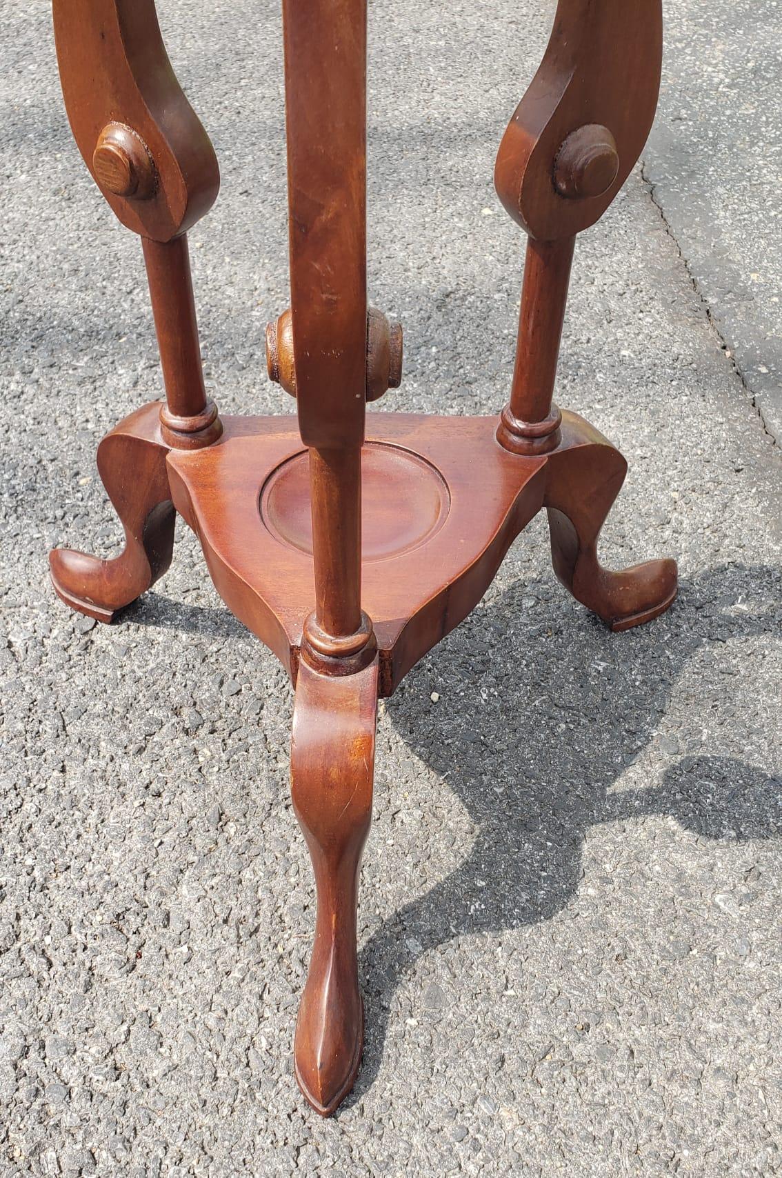 A well crafted victorian style mahogany pedestal plant stand with with barley twist legs