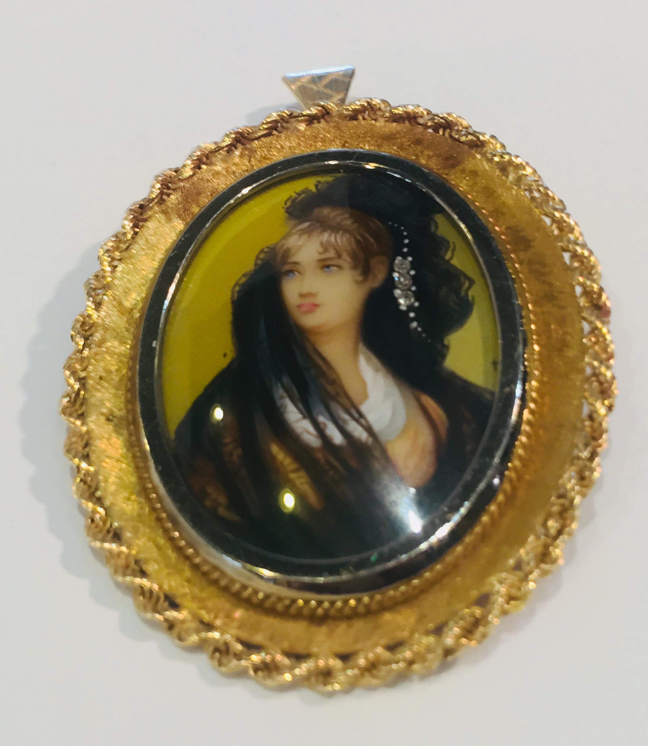 Lovely oval shaped pendant or brooch has a hand painted miniature painting of a beautiful young woman with 3 diamonds accenting her veil.  Painting is protected with a white gold, bezel set crystal, with a frame of 18 karat yellow gold Florentine