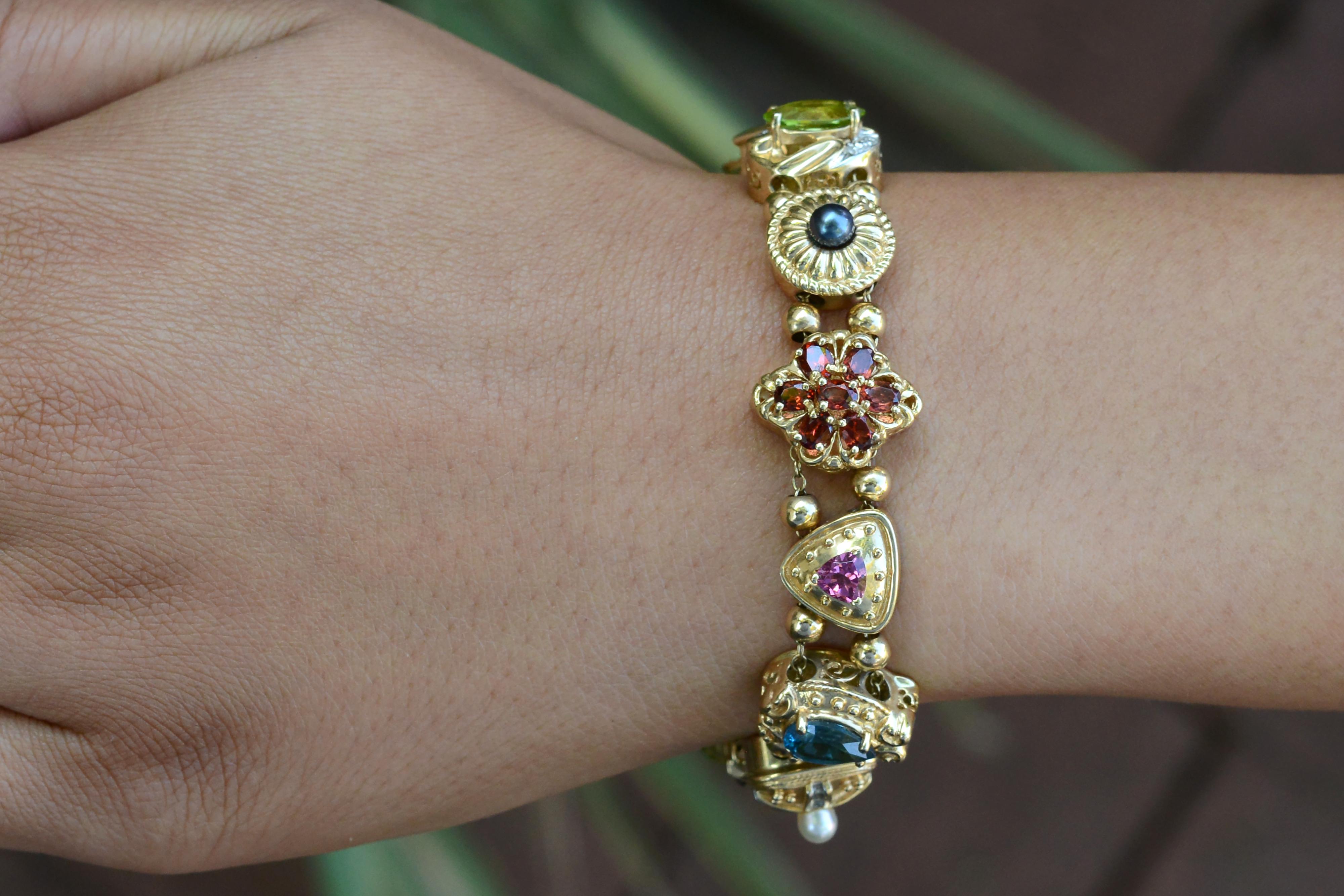 Vintage and lively with charm, this Victorian inspired slide bracelet displays a multitude of natural gemstones. From pearls to diamonds, to lush green peridot, onyx, blue topaz, citrine to luxurious garnets. Originally fabricated from stickpins