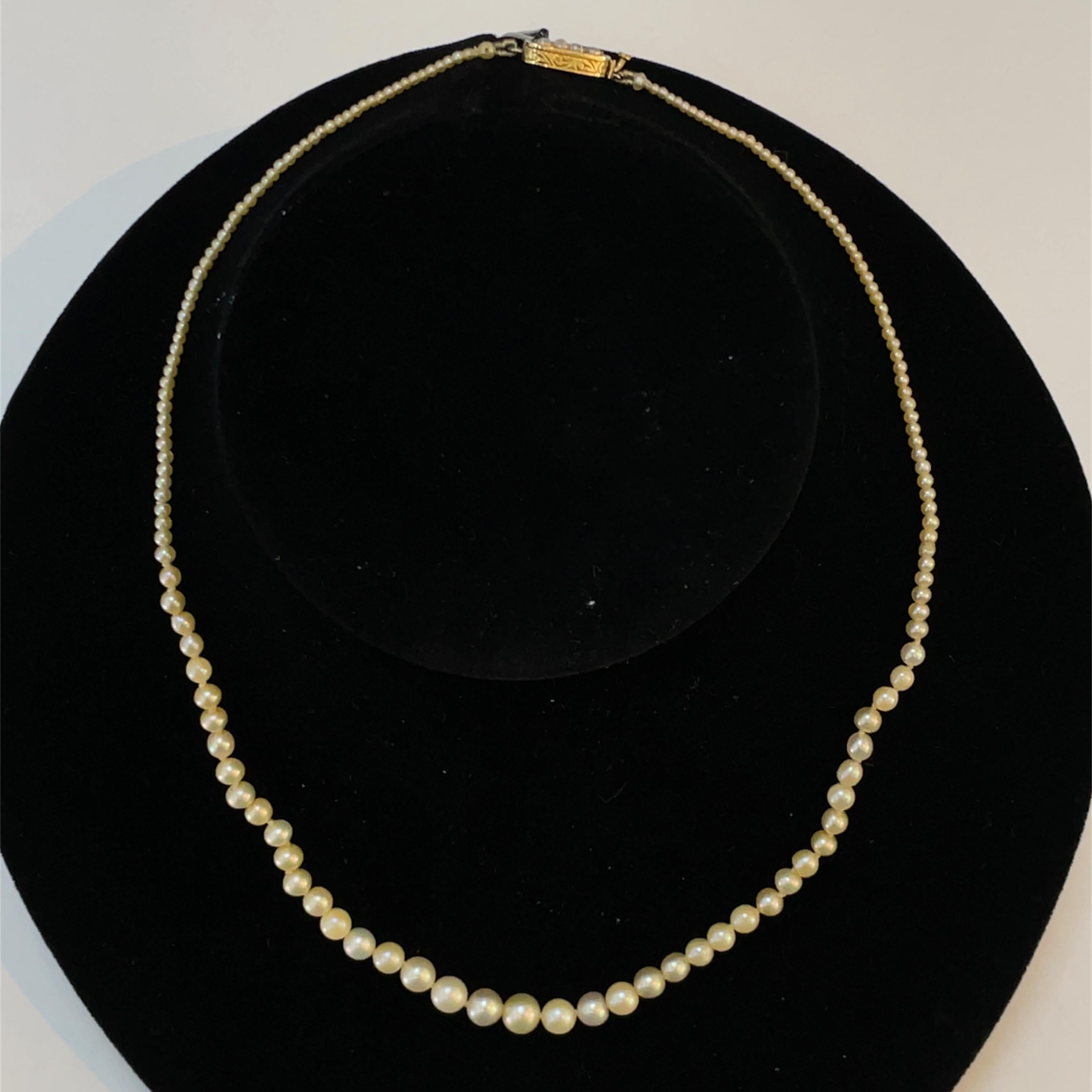 Elevate your elegance with this exquisite necklace featuring a stunning strand of Victorian natural pearls, beautifully complemented by an 18k yellow gold clasp. Measuring 15.5 inches in length, this piece is designed to sit gracefully on your