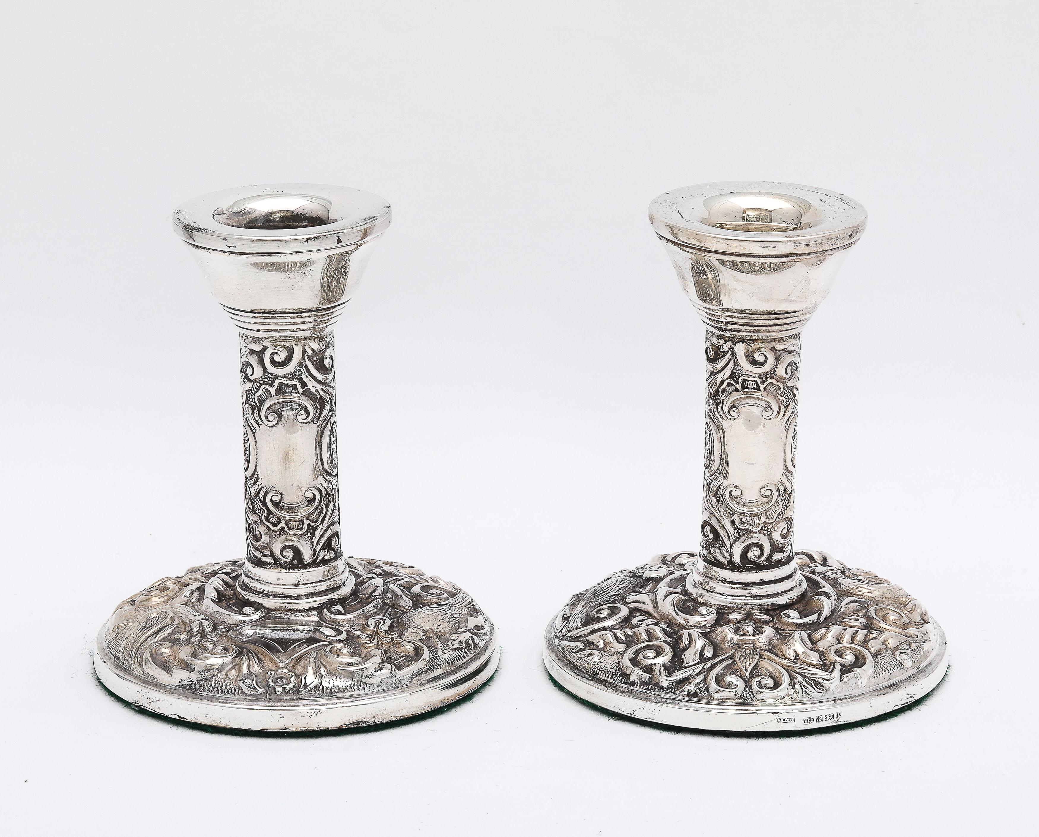 Pair of Victorian-Style sterling silver candlesticks, Birmingham, England, year-hallmarked for 1995, Broadway and Co., Ltd.- makers. Each candlestick measures approximately 4 inches high x 3 1/4 inches diameter (across base). The pair is weighted.