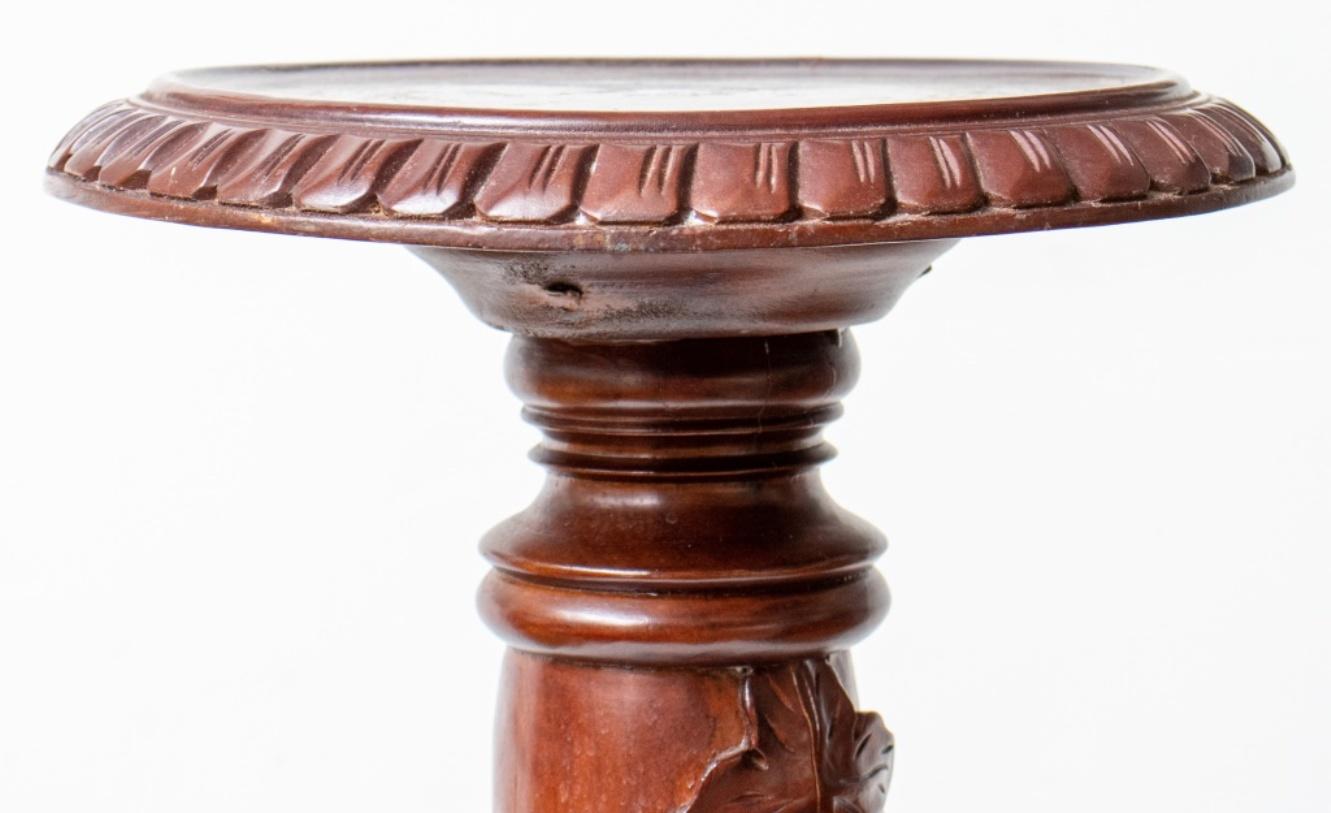 Round Victorian style pedestal, with round top above a shaft encircled by grapevines on tripod base. Measures: 41