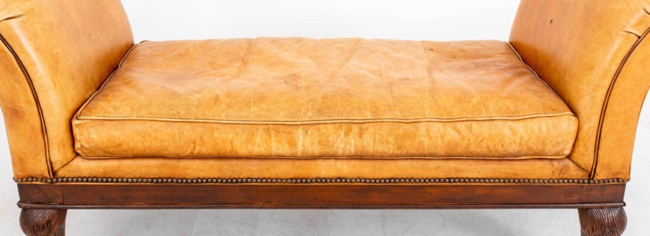 Victorian Style Scroll Arm Upholstered Settle, the toffee colored leather upholstery over scrolling arms and a drop in seat cushion above a molded seat rail on four hairy lions' paw feet. 

Dealer: S138XX