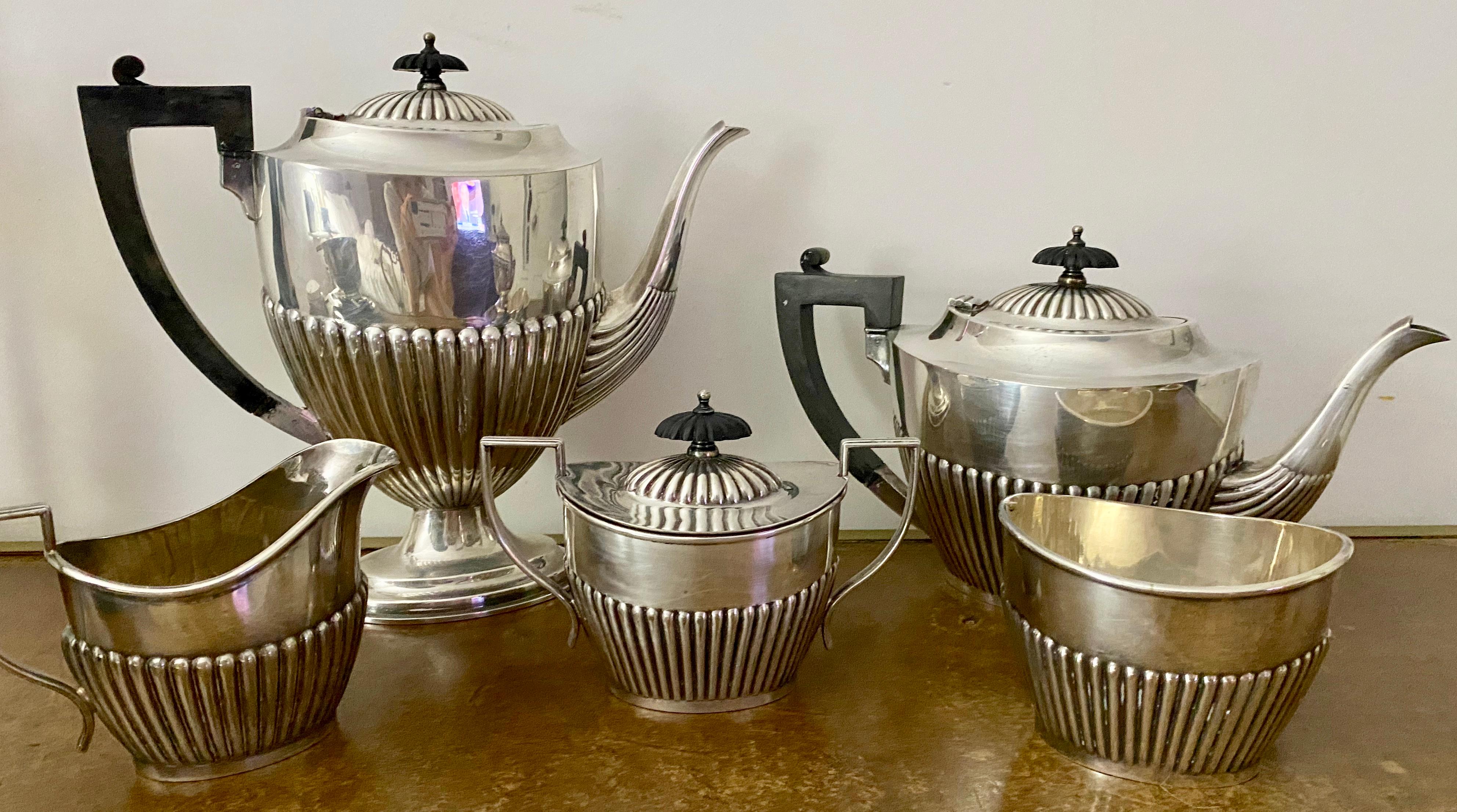 Entertain in style with this Victorian Queen Anne Style silver-plate tea set with black bakelite handles and lid knobs. The lower portion of each item is embellished with embossed fluted decoration in the Queen Anne style.
Coffee pot - 11 x 4.5 x