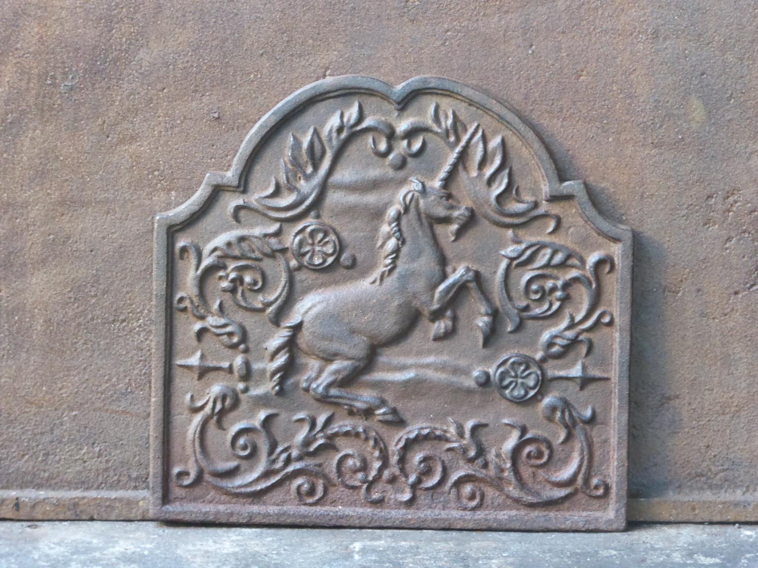 20th century Victorian fireback with an unicorn surrounded by various decorations. The fireback is made of cast iron and has a natural brown patina. Upon request it can be made black. The fireback is in a good condition and does not have