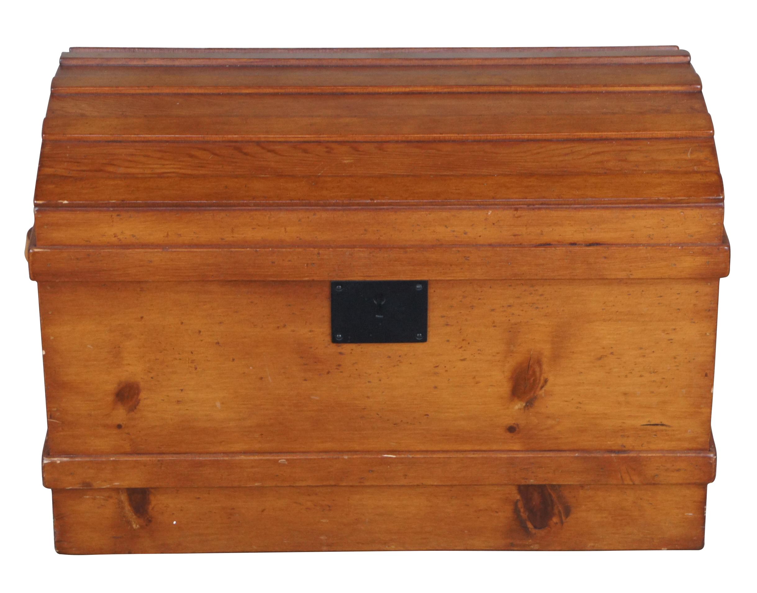 A Victorian style dome top trunk from the latter half of the 20th century. Made from pine with leather handles and an iron escutcheon plate. Opens to a striped linen interior with removable tray.