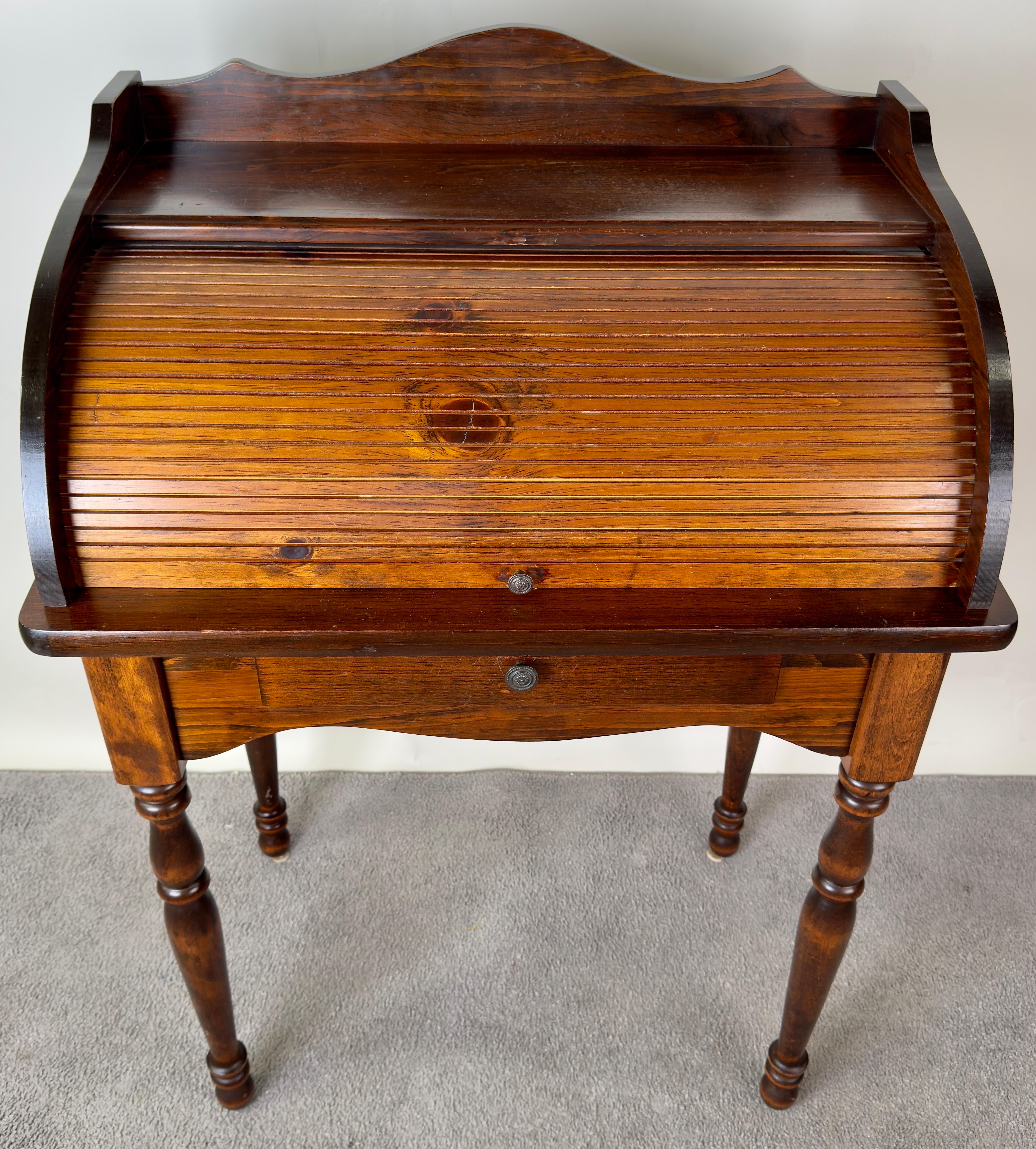 Victorian walnut roll-top desk, the tambour front enclosing maple front drawers and pigeonholes, slide fitted with writing slope with inset leather surface, over two drawers on turned supports.

An enchanting Victorian style roll-top desk with