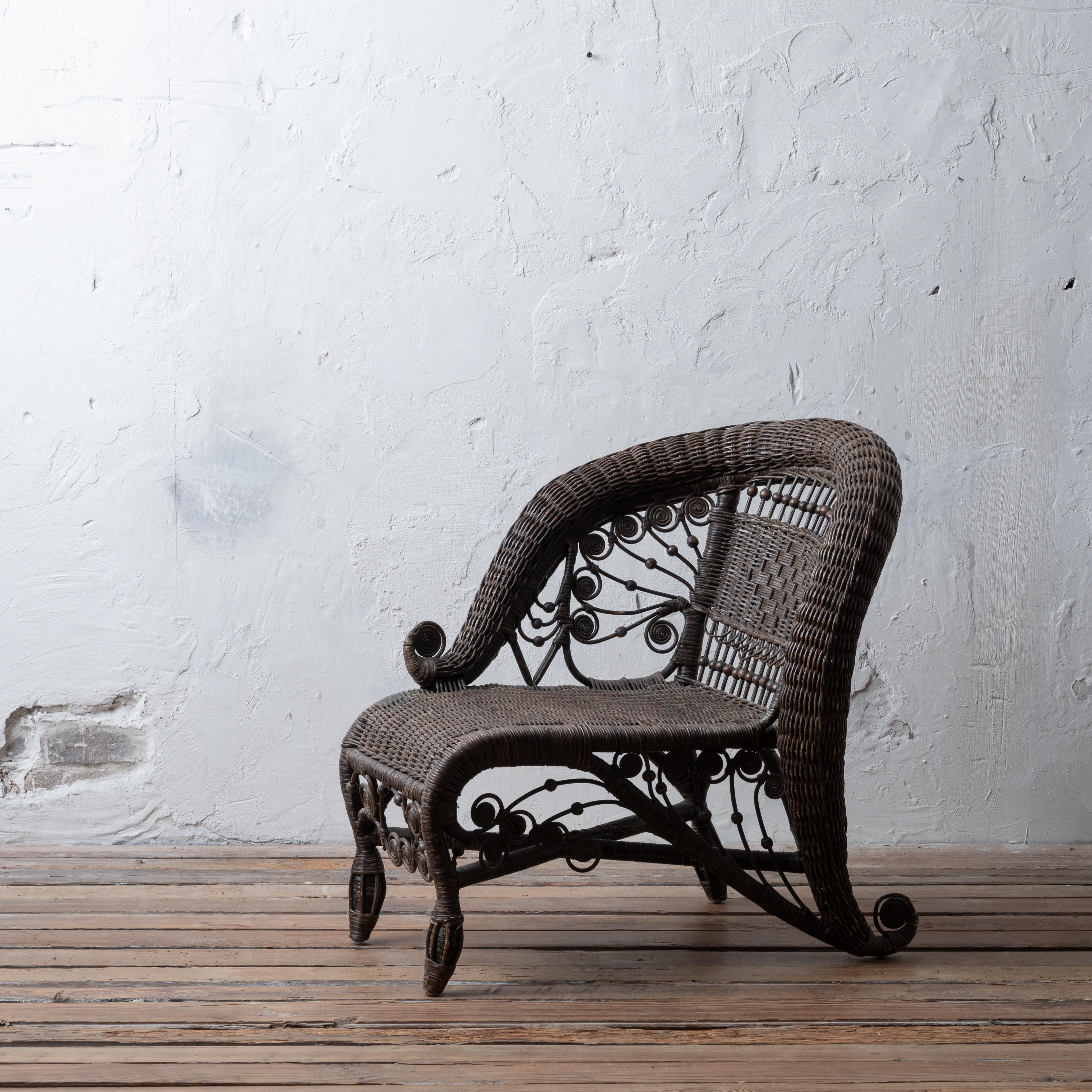 A Victorian style wicker child’s photographer’s studio lounge chair, late 20th century.

27 ½ inches wide by 21 inches deep by 27 inches tall; seat height 13 inches

