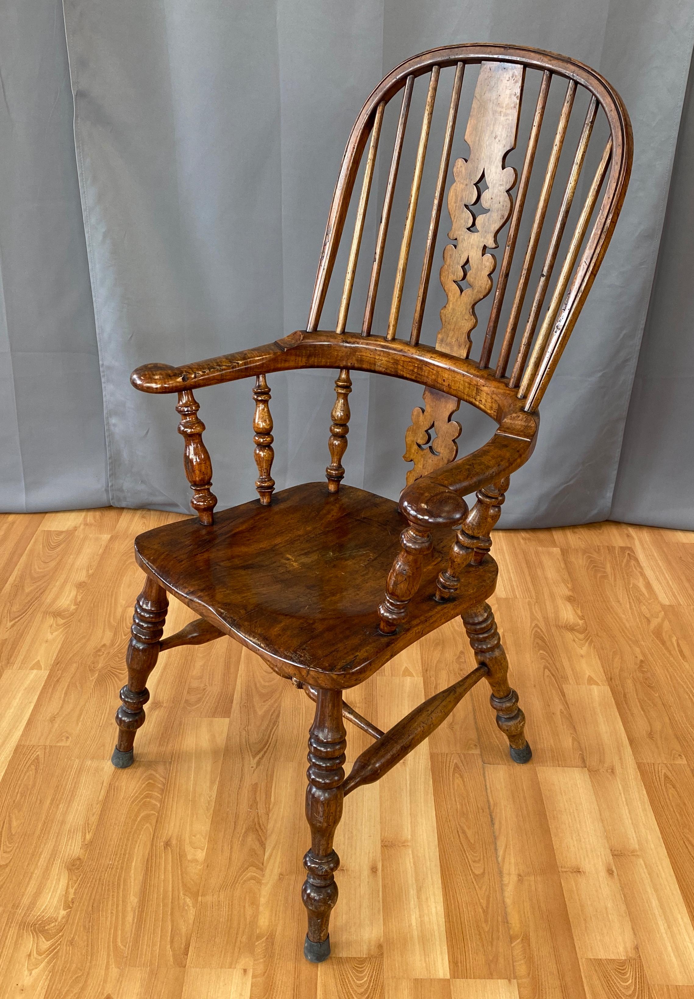 Offered here is custom crafted Windsor hoop back arm chair. 
With large proportions, starting with turned legs with a single stretcher
joining the pairs, generous seat, broad arms, high back with a carved center slat in the middle of a nice set of