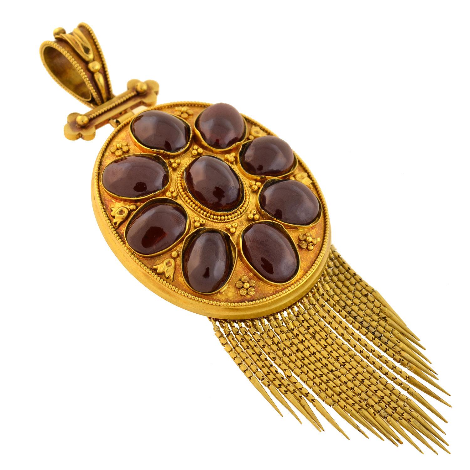 An absolutely incredible garnet locket pendant from the Victorian (ca1880) era! Crafted in vibrant 18kt yellow gold, this wonderful piece, which is particularly large in size, is detailed with several fabulous garnets surrounded by fine Etruscan