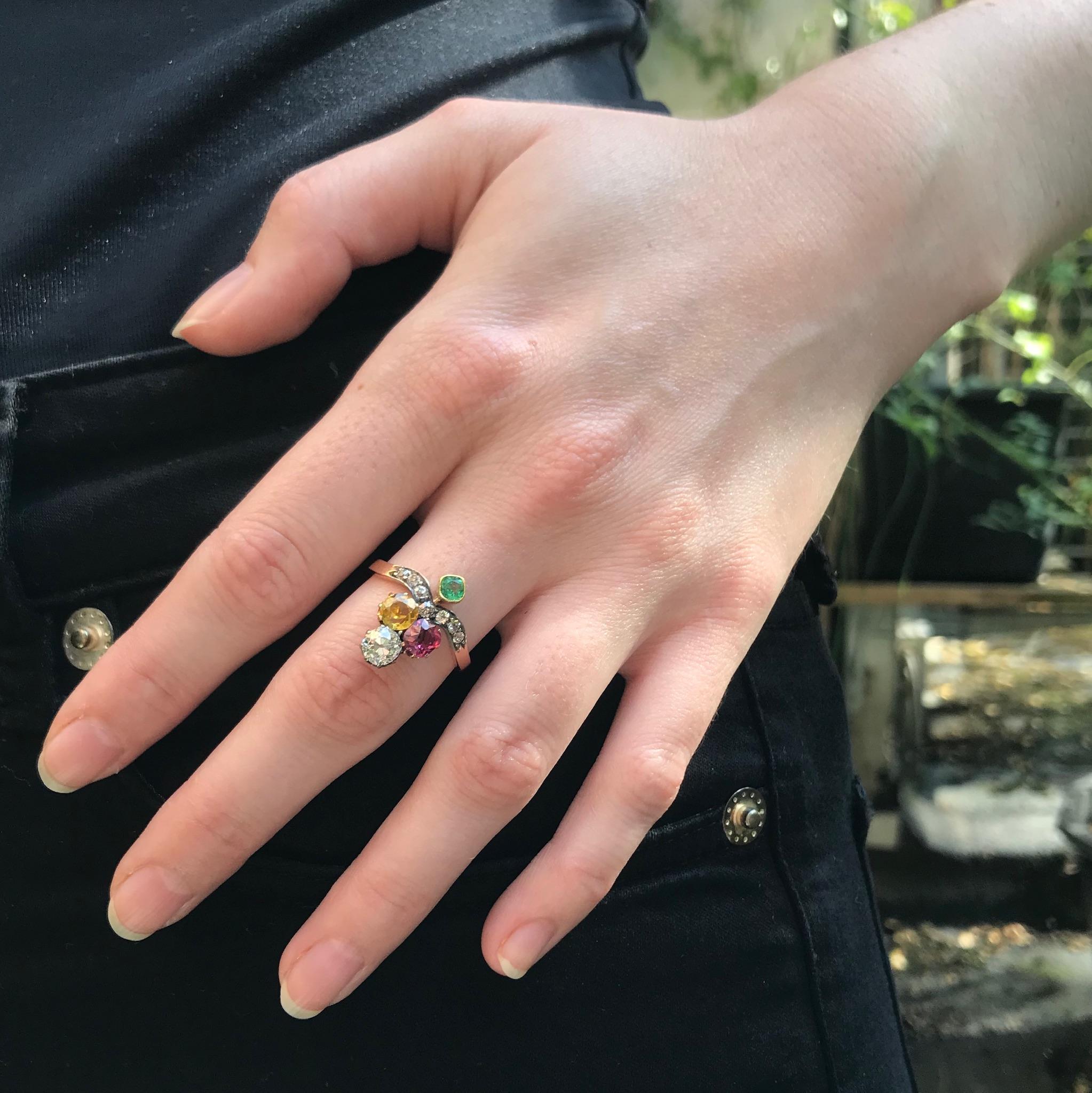 A fine Victorian suffragette engagement ring in 18 karat rose gold set with 1 old European cut diamond .60 carat (color and clarity: G/H, vs), 7 old European cut diamonds totaling .32 carat (color and clarity: G/K, si/i), yellow beryl .39 carat,