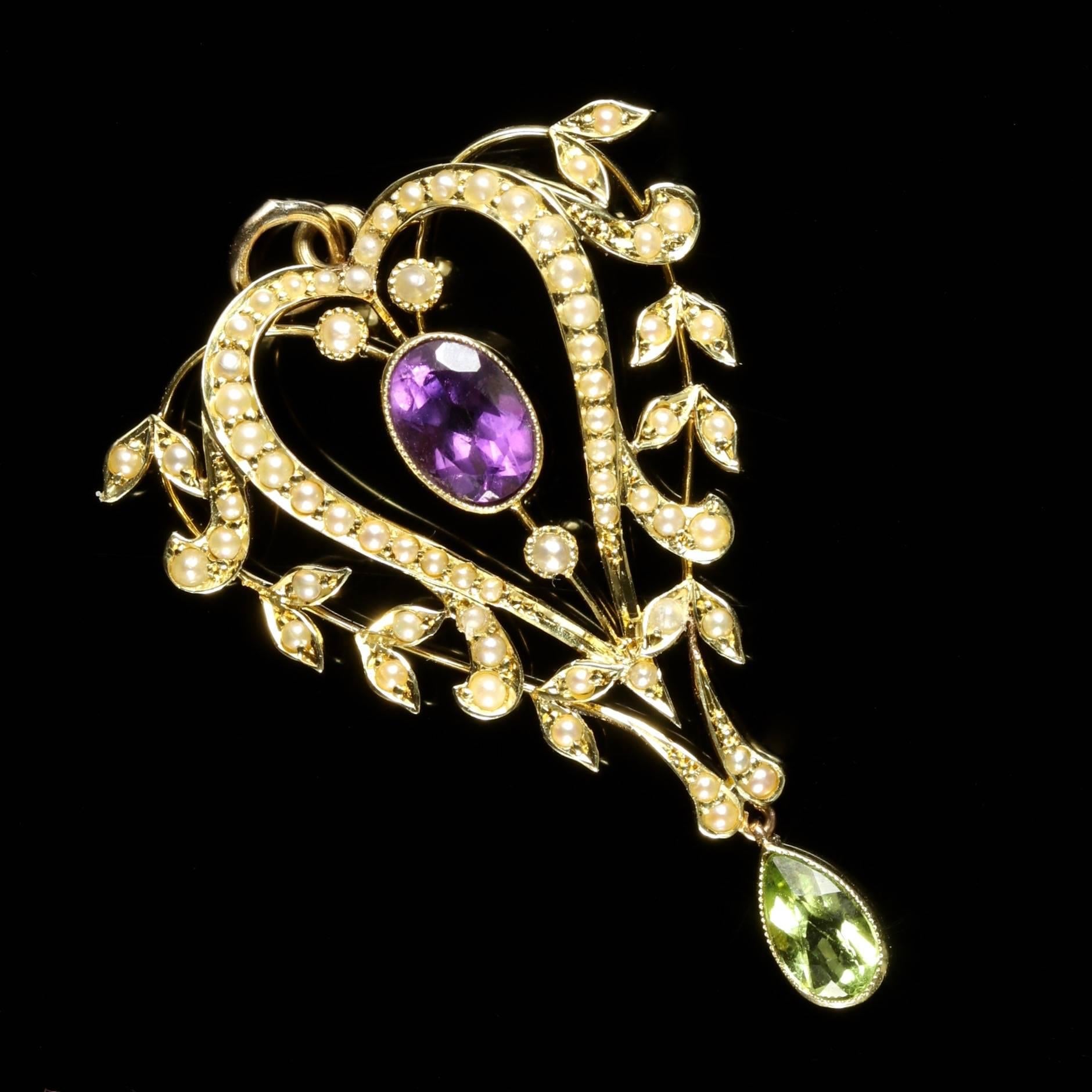 This beautiful 15ct Yellow Gold Victorian Suffragette heart pendant is adorned with a Amethyst in the centre which is surrounded by Pearls, finishing with a green Peridot dropper.

The pendant is decorated in lovely Pearls, and boasts a violet