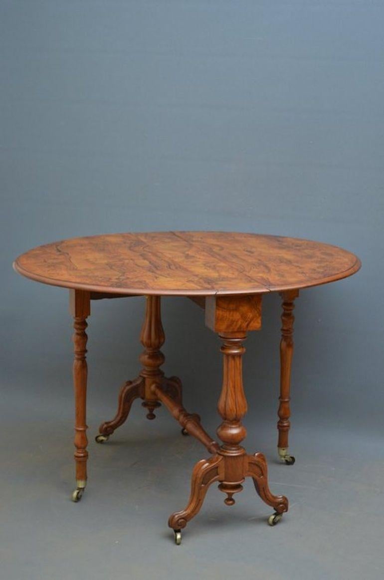 Sn3806 Very elegant, Victorian, drop leaf, Sutherland, occasional table, having attractive burr walnut, oval top, raised on fluted, turned end supports terminating in carved cabriole legs and original brass castors all united by turned stretcher.