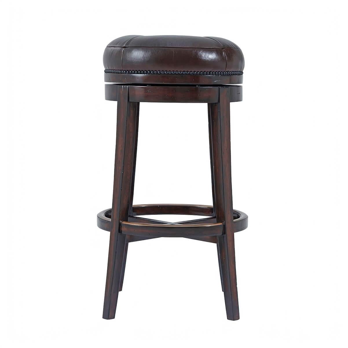 An English Victorian style swivel bar stool, the circular button upholstered turning seat above splayed legs joined by a brass mounted ring stretcher. The original Victorian.

Dimensions: 20