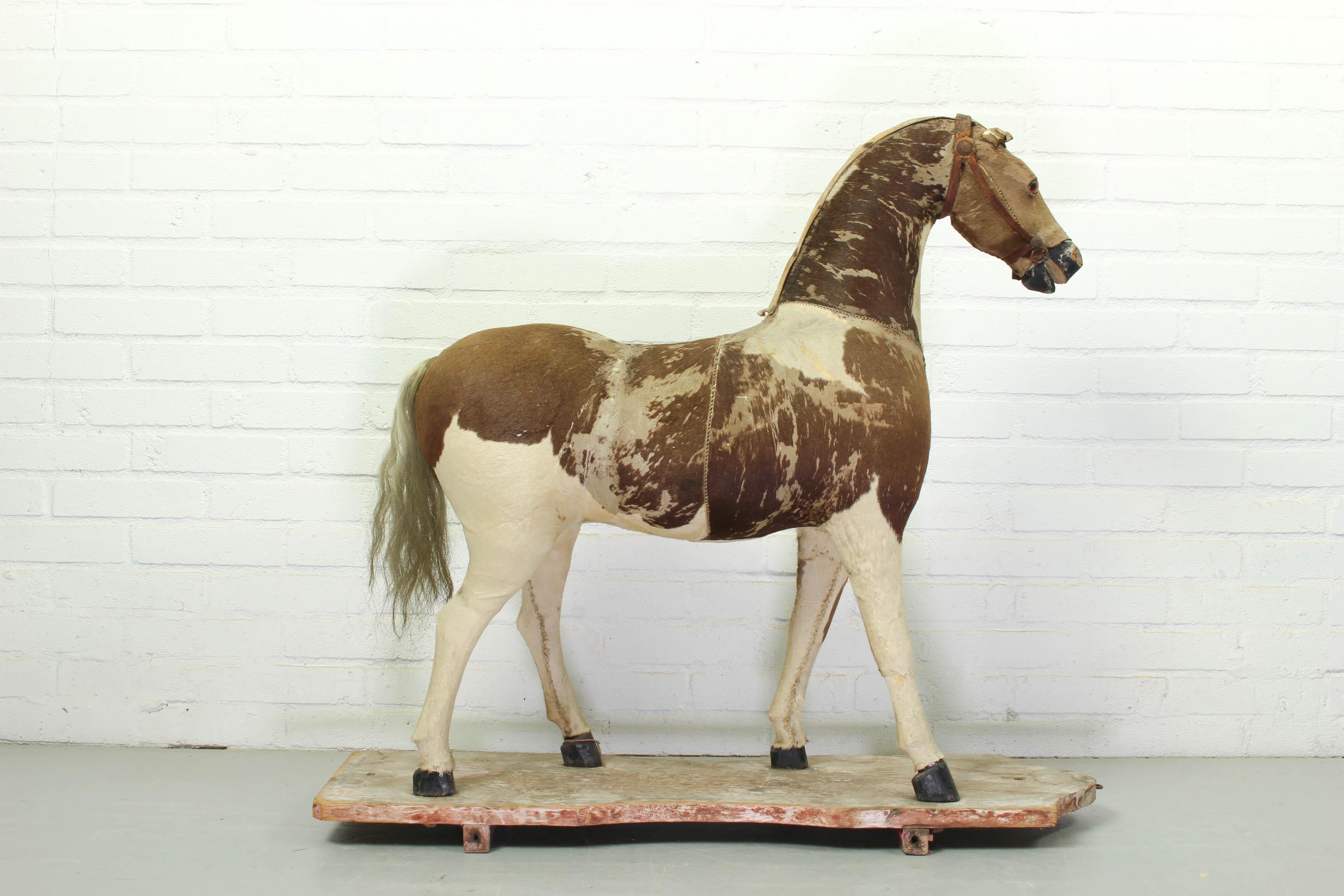 Victorian taxidermy toy horse, late 19th century. Unusual and rare, this model of a horse with glass eyes, is made of a stuffing material covered with a real animal fur hide stitched together. The horse has traces of use and he is obviously used and