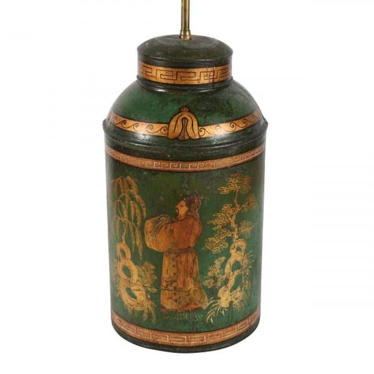 A middle of the 19th century Victorian tea tin.

The tea tin has a green background that has gilt chinoiserie decoration.


The tea tin has been converted into a table lamp and has a brass twin lamp holder fitted into the top.

The tea tin
