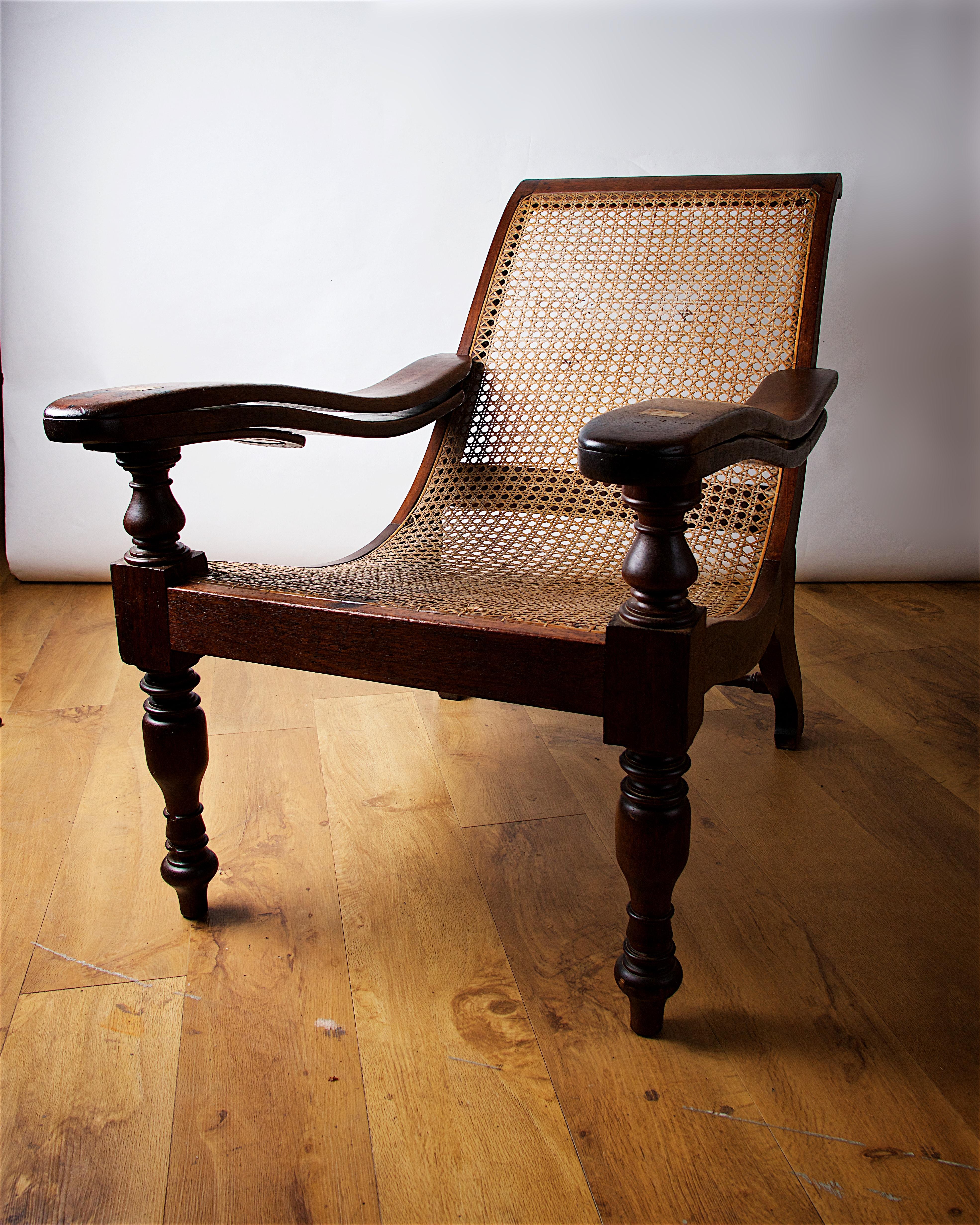This teak and rattan plantation chair came from the family home of Hercules Linton, one of the nautical architects who designed the Cutty Sark. The chair was made in Columbo, Ceylon sometime in the Victorian era. 
Dimensions: D: 40in x W: 26.5in x