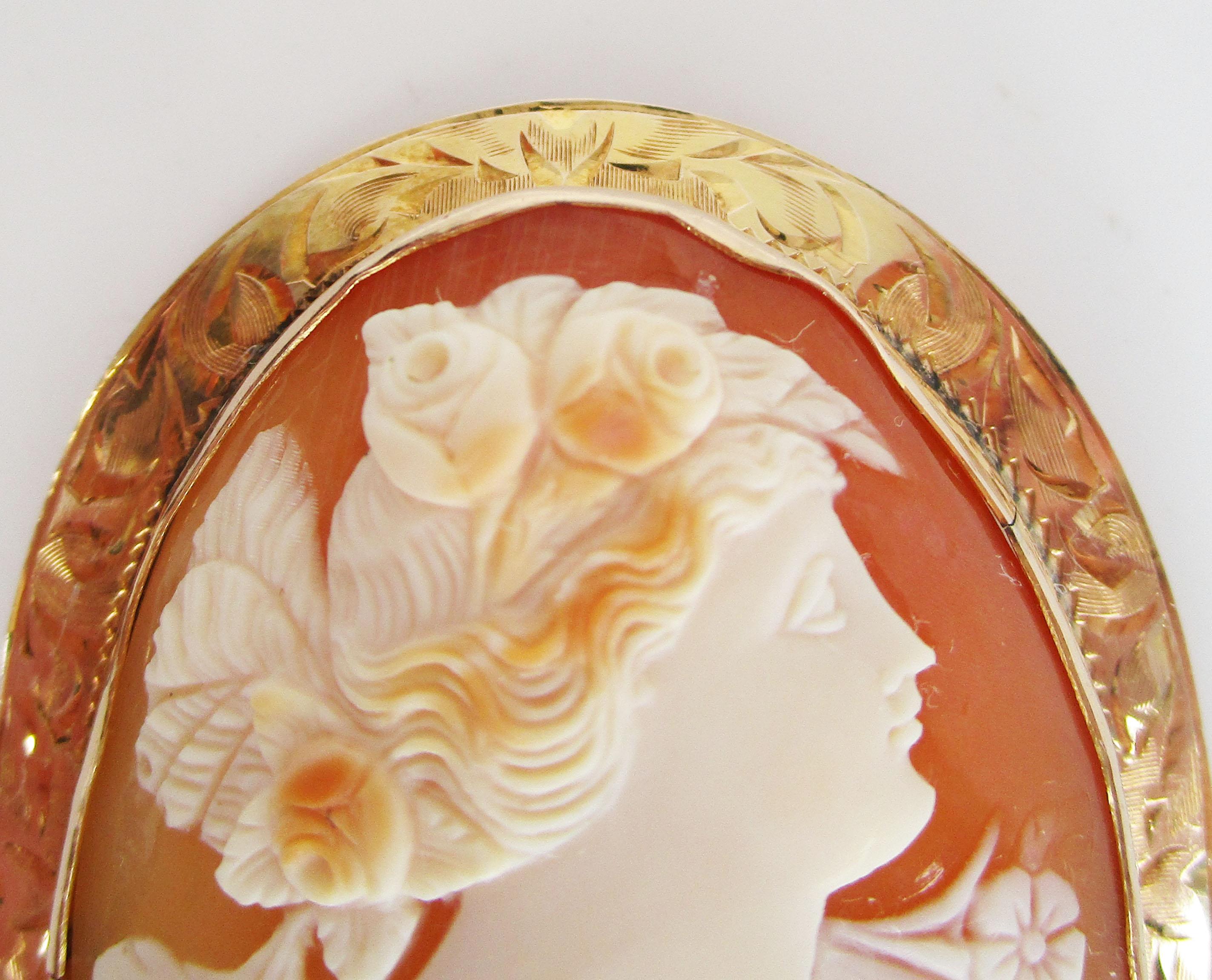 This is a breathtaking original Victorian hand-carved 3 color shell cameo in 10k yellow gold. The 10k yellow gold frame is decorated with beautiful engraving in a design that has a subtle floral look. The brightness of the yellow gold serves as the