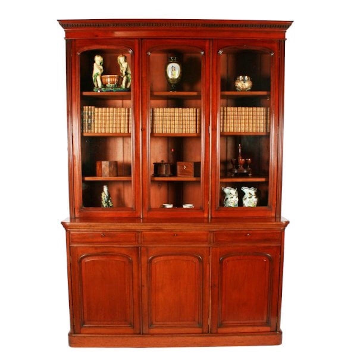 A 19th century Victorian mahogany three door bookcase.

The glazed top has a pair of doors that open to four adjustable shelves, (only three are shown in the photos), and a single door that again opening to four adjustable shelves.

The base has