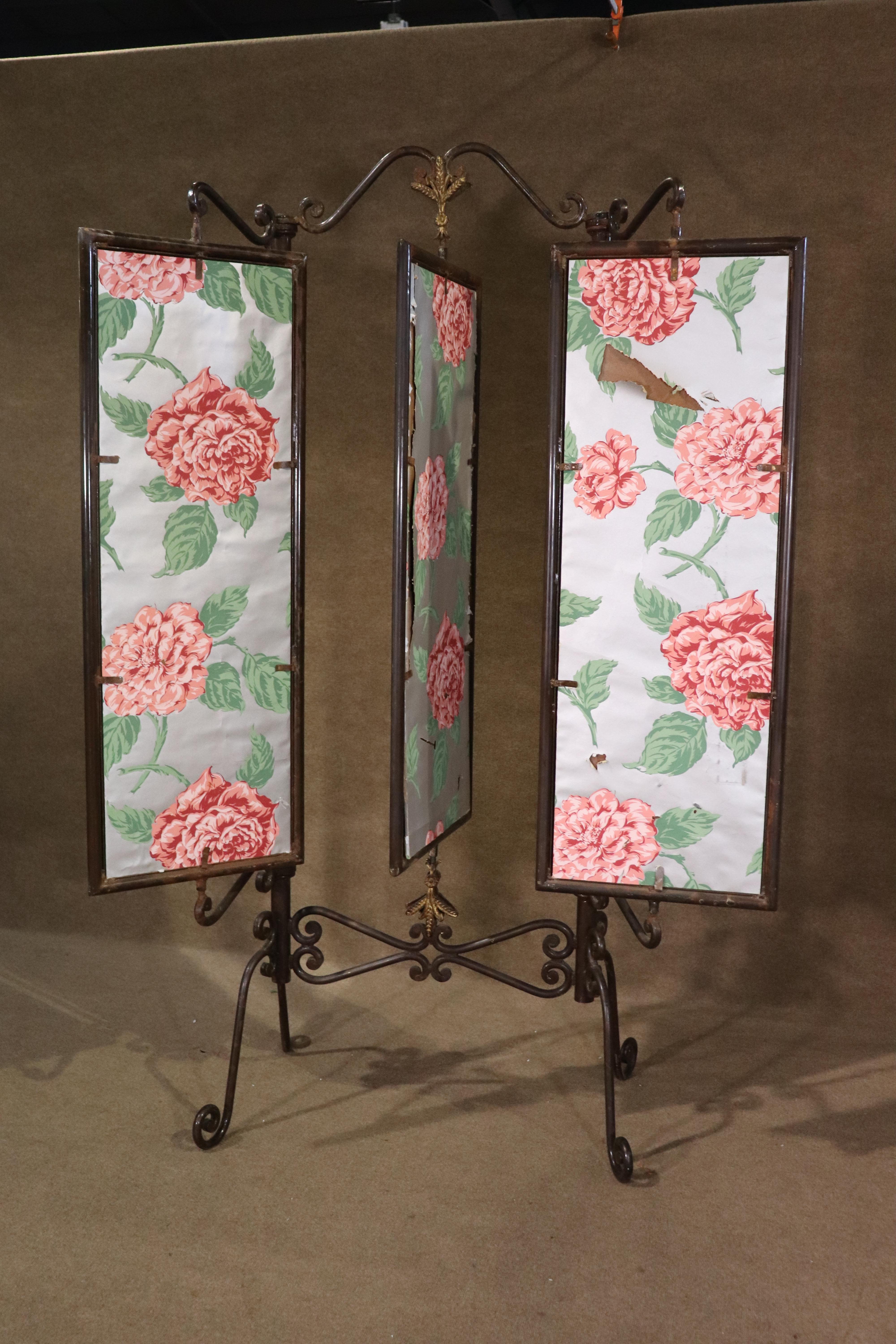 Antique dressing mirror made of strong iron with decorative embellishments. Three movable mirrors with floral paper on back. 
Please confirm location NY or NJ