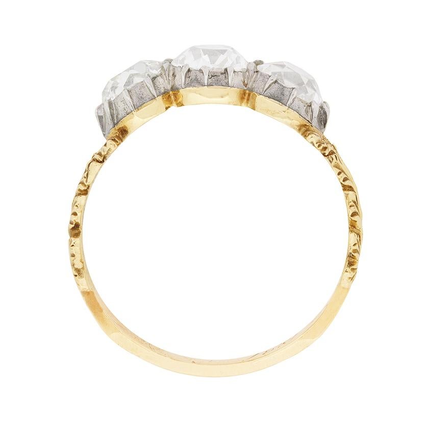 An uncommon and romantic three stone diamond ring with history, engraved ‘F.C.J. Oct 1881’.

Set in 18 carat yellow gold, with the diamonds mounted in platinum, this antique ring is set with 2.10 carats of old cut diamonds.

The ring’s handmade