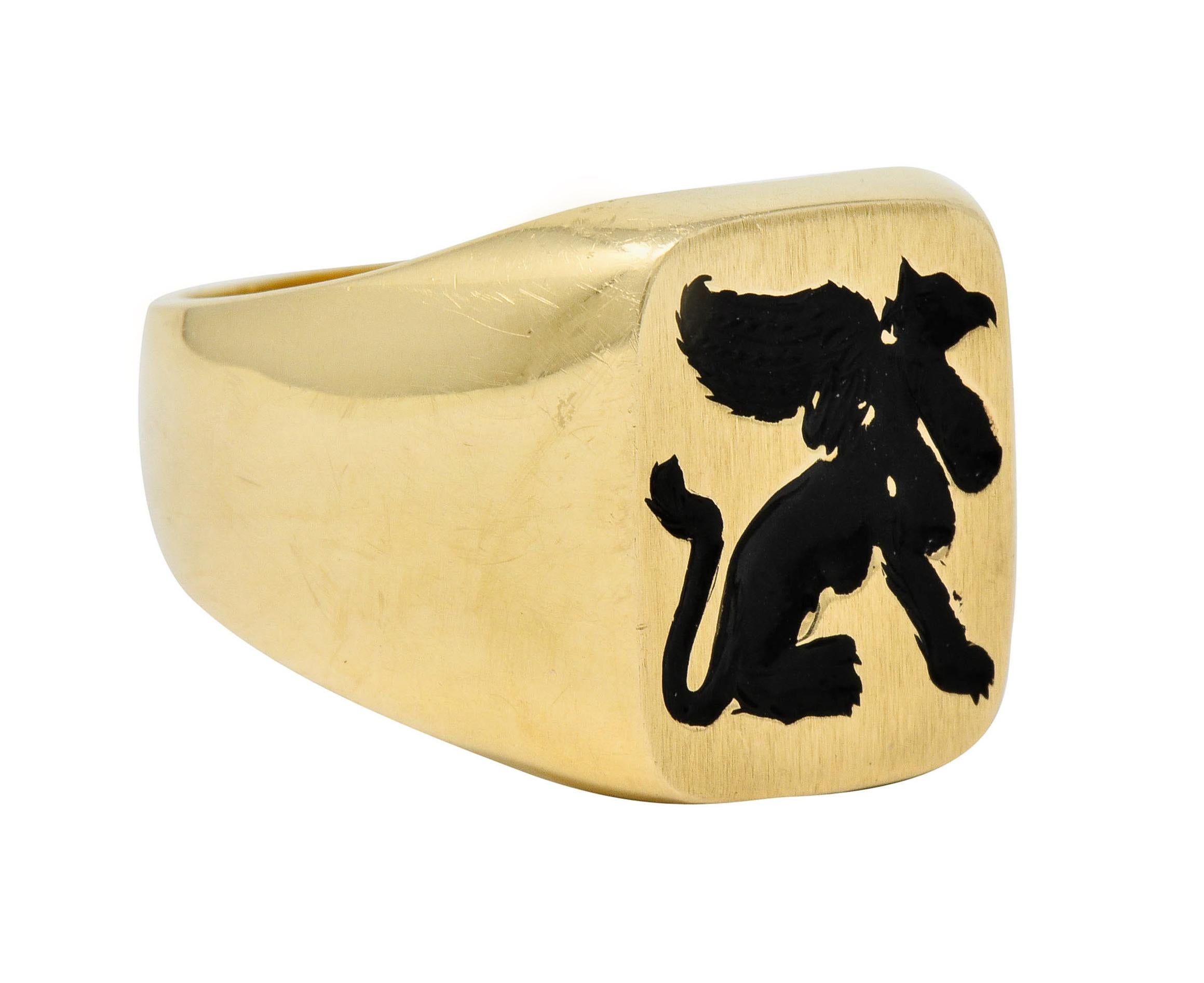 Signet style ring deeply engraved to depict the silhouette of a winged gryphon

Glossed with black enamel exhibiting some loss; consistent with age, wear, and use

Cushion shaped face features a lightly brushed finish while remainder of ring is
