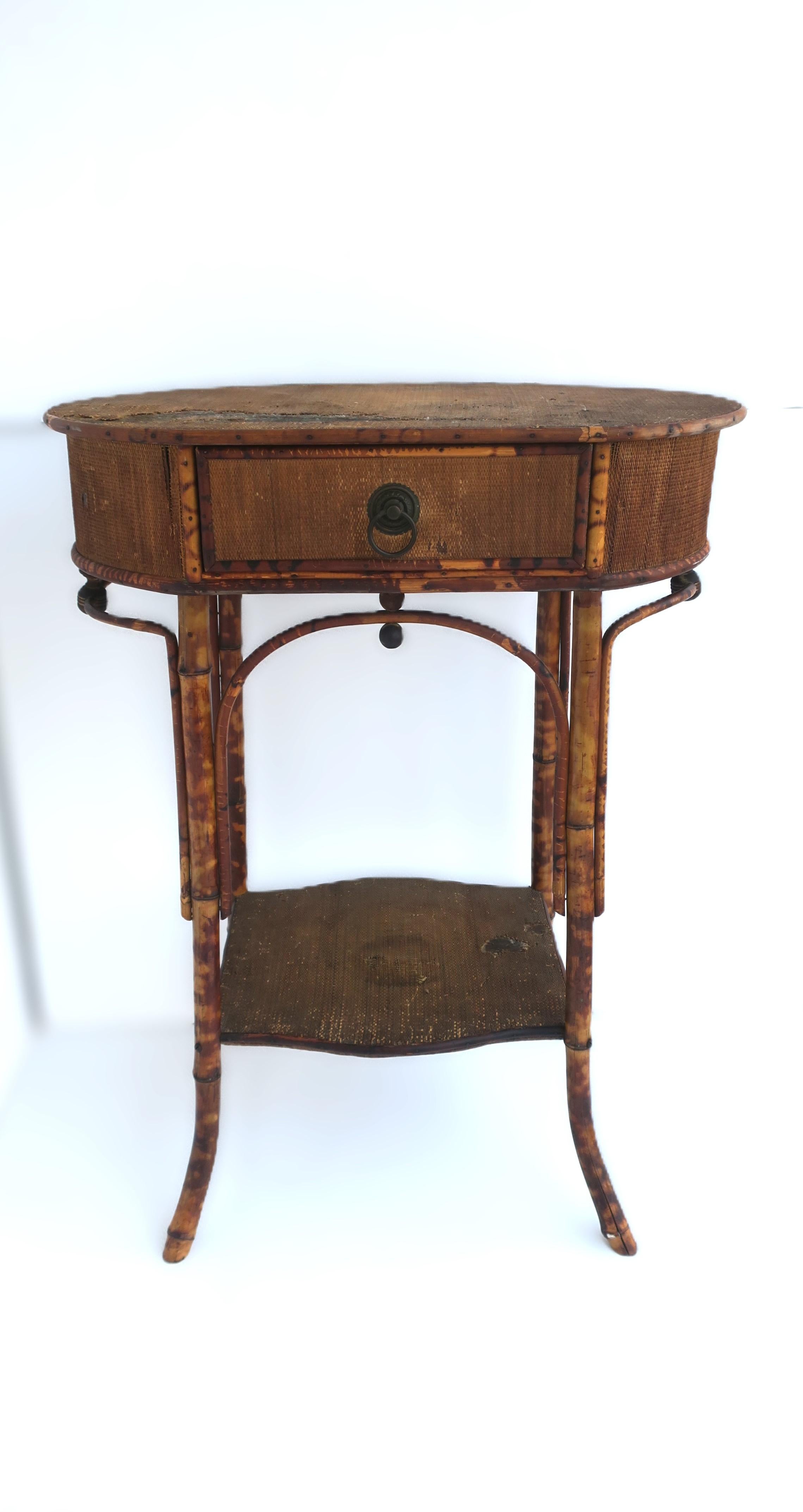 An English bamboo and wicker hall foyer table with draw and shelf, Victorian period, circa late-19th to early-20th century, England. Piece also exhibits some design elements of the Art Deco period as shown in images. Table (hall, foyer, vanity area,