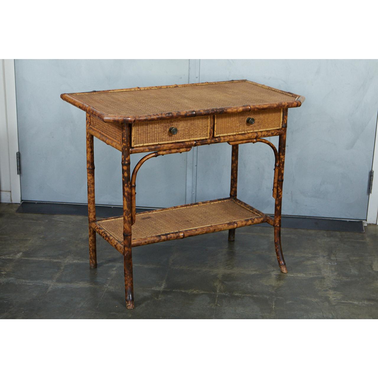 This nice tiger bamboo table/desk has two shaped corners and two squared corners. The table has one narrow shelf allowing for use as a desk. The table has reinforced bamboo legs waxed cane matte. 

 