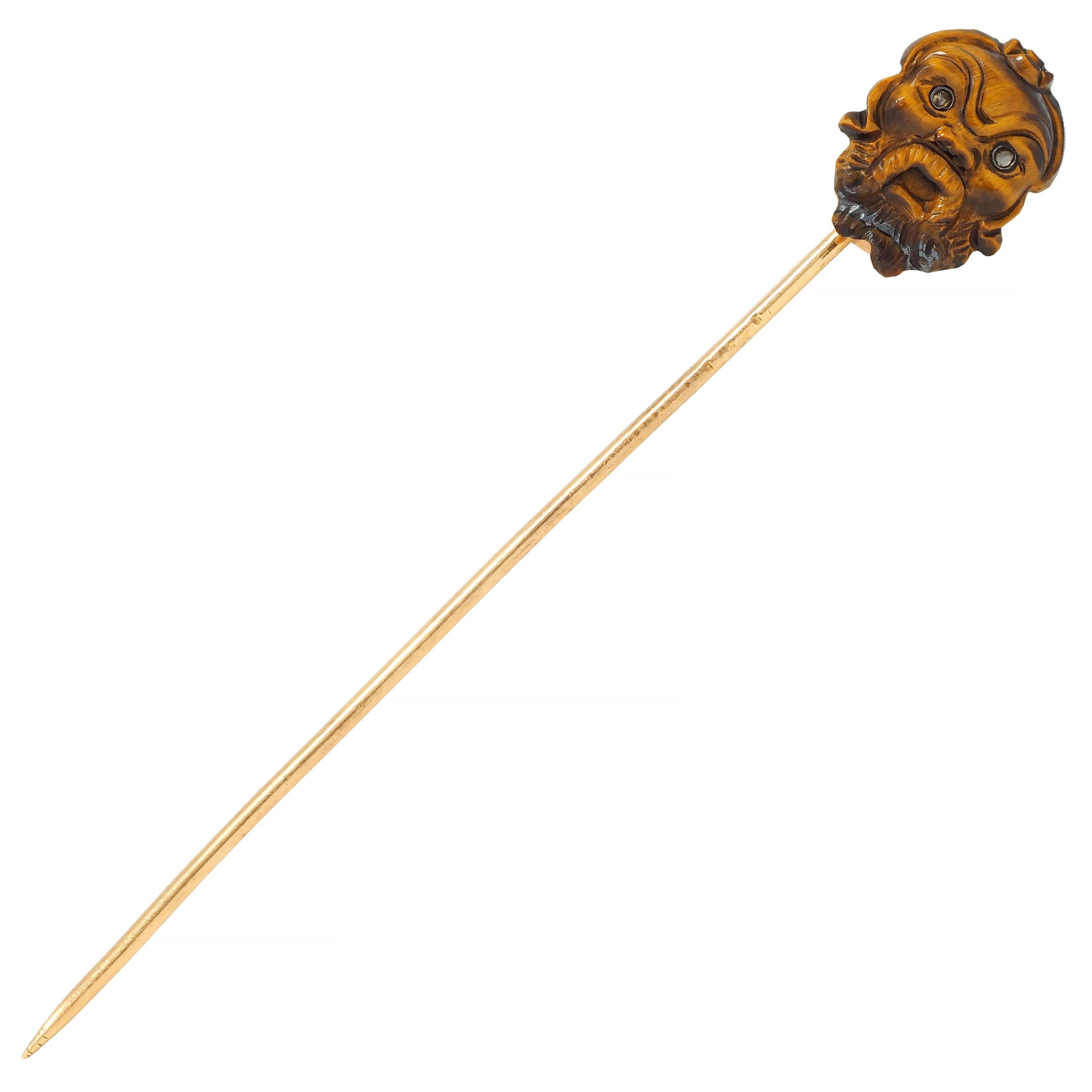 Designed as a highly rendered Japanese Kabuki mask carved from tiger's eye
Opaque striated brown to orangey brown in color displaying linear chatoyancy
With a furrowed brow, textured beard, and rose cut diamond eyes
Bezel set in silver with quality
