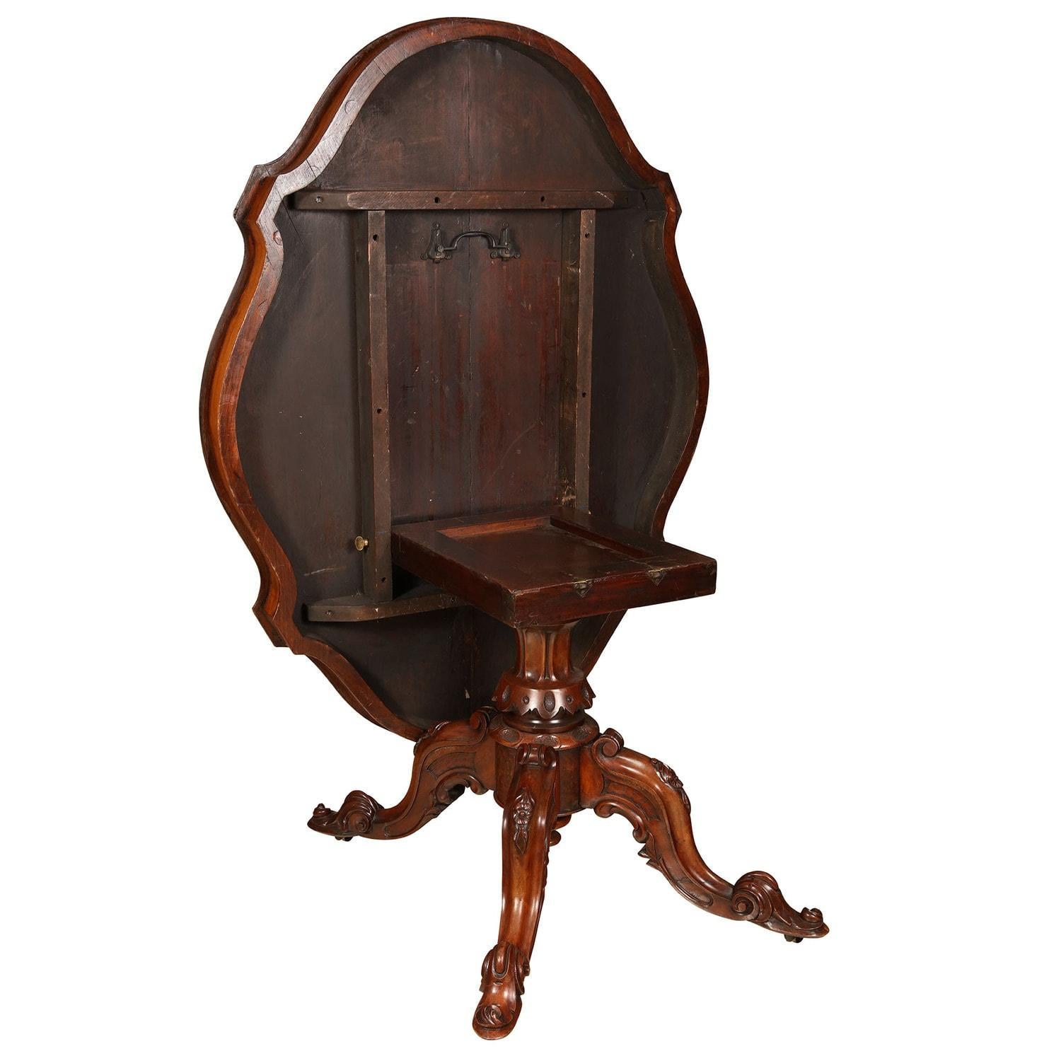 A Fine late 19th century tilt-top centre table with scalloped top, quarter veneered bookmatched veneers of highly figured burr walnut and inlaid with a foliate marquetry central panel and borders, raised on a pedestal base with carved scroll feet