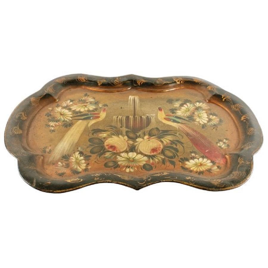 A mid 19th century Victorian serpentine sided tolé ware tray.

The tray has a black background, a gold edge and a pair of hand painted birds by a fountain hand painted in the centre.

The tray is in good condition, there is some minor wear to