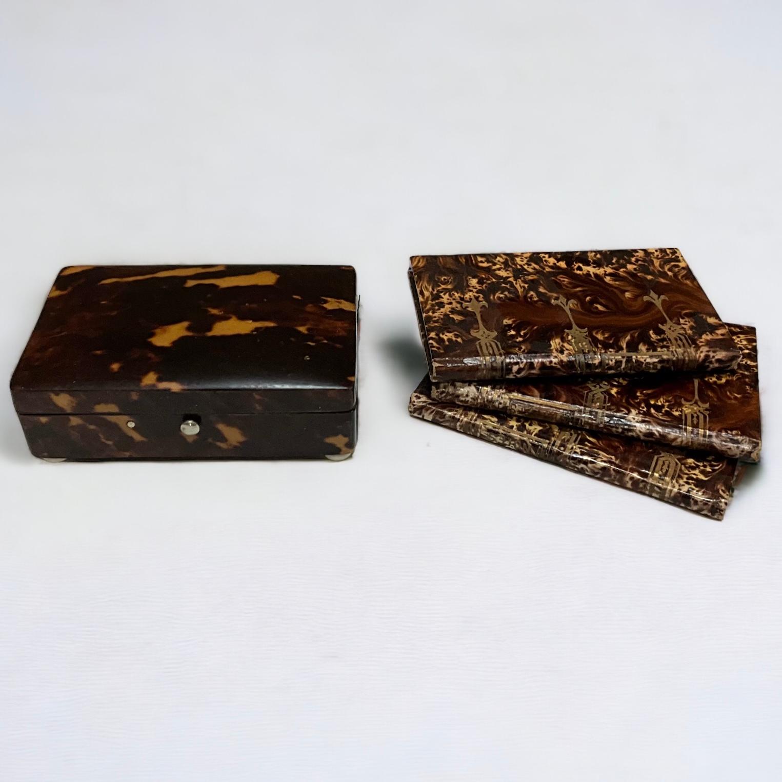 Holiday Gift Idea! This is a late 19th century English tortoise shell desk box paired with a set of three Italian faux tortoise leather notebooks. The notebooks have not been used. They most likely date to the 50s. The books are 3”L x 4.25”H.