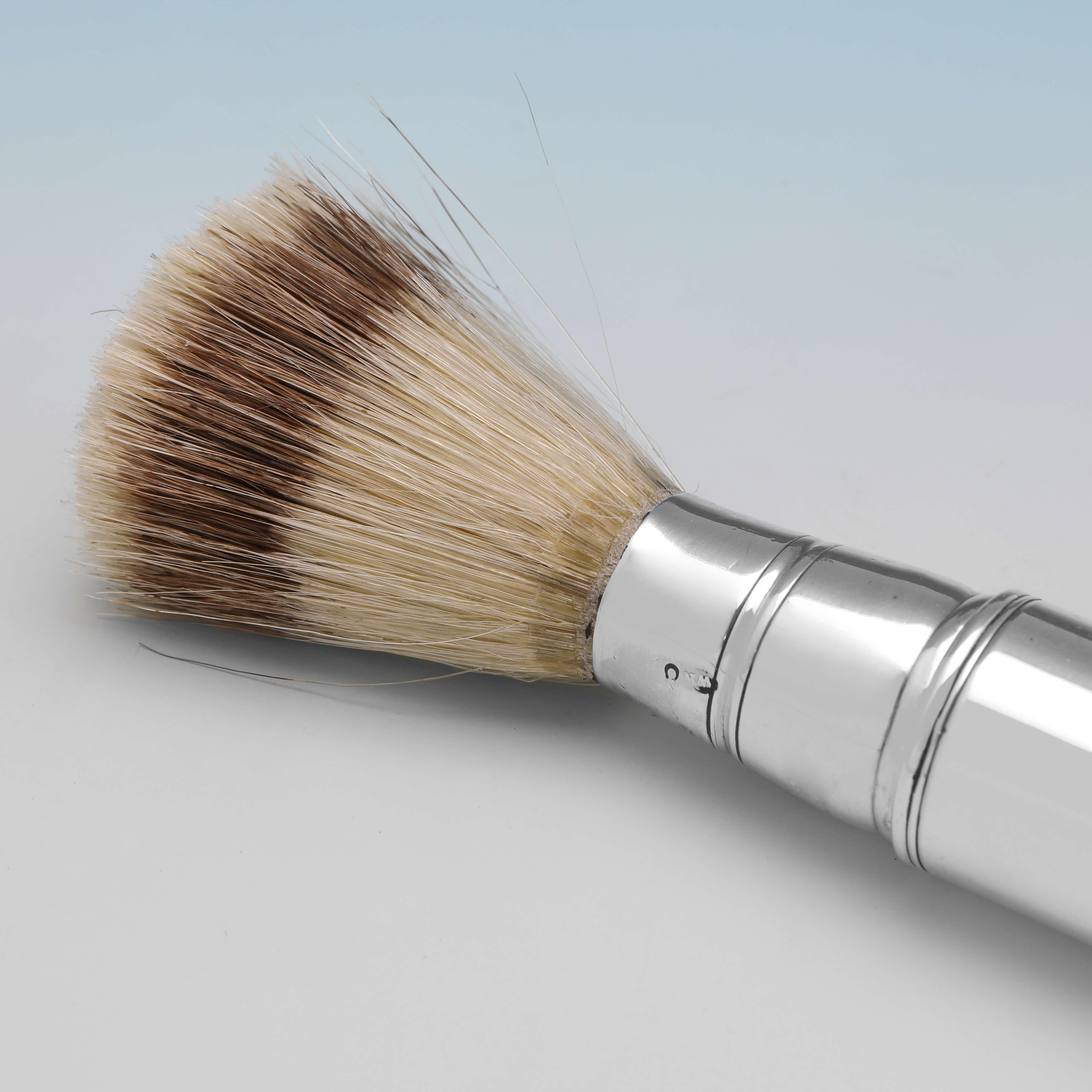 Hallmarked in London in 1856 by William Neale, this handsome, Victorian, Antique Sterling Silver Shaving Brush, is plain in style, with a replaced badger hair brush, and can be unscrewed and fitted together for travel. 

The shaving brush makes an