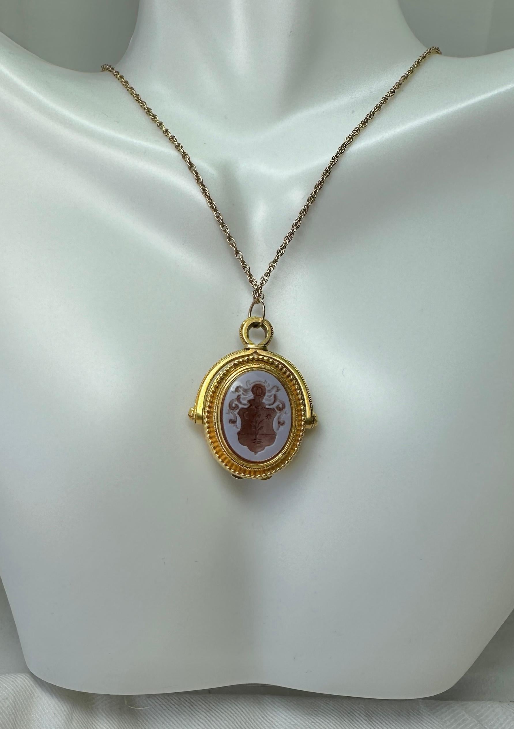 This is a rare and wonderful antique carved Crest Shield Victorian Etruscan Revival Locket Pendant with Banded Agate or Sardonyx gems.  The locket is in the Etruscan Revival style. One side is adorned with a carved banded agate intaglio with an