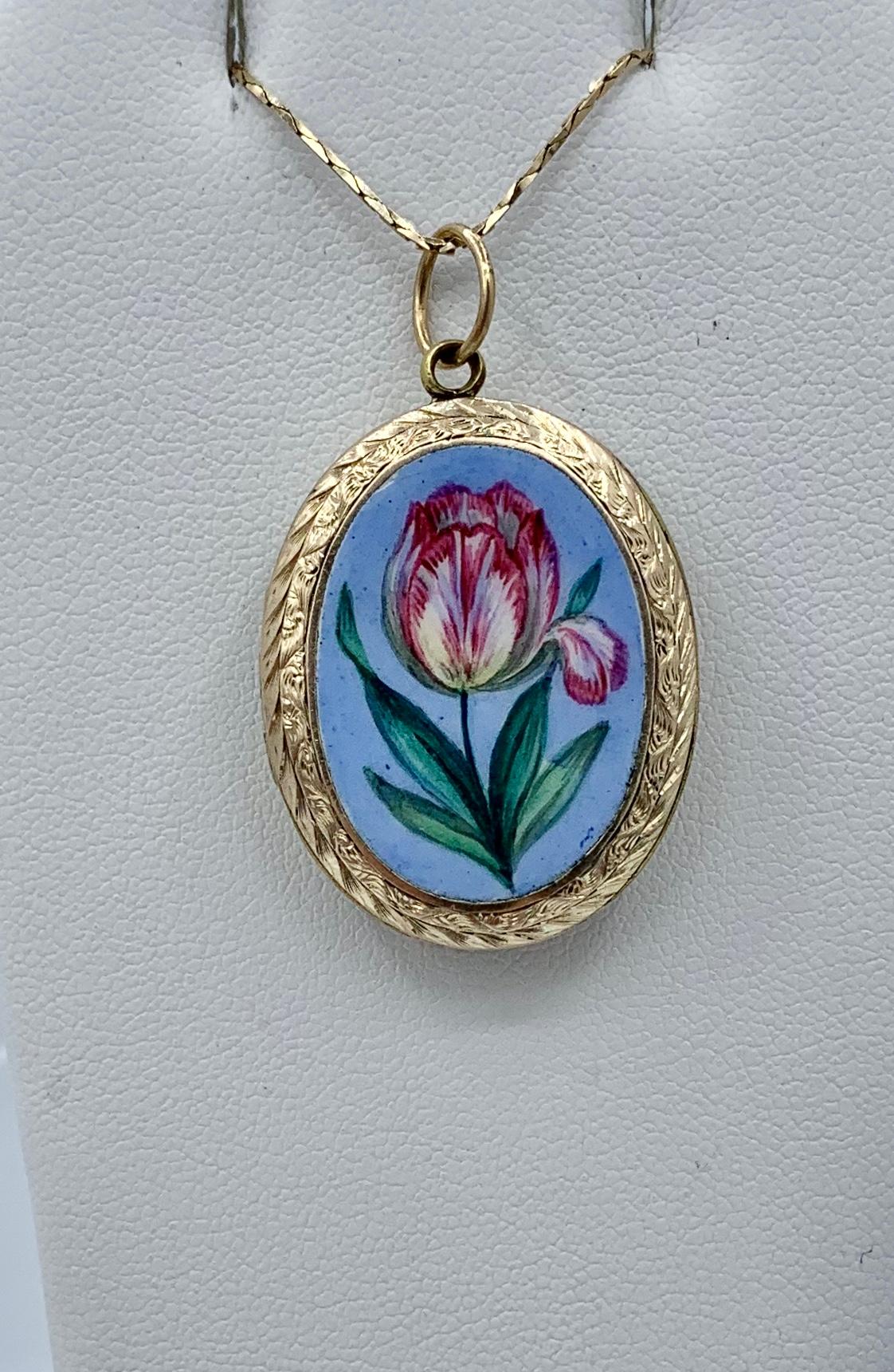 This is a rare and wonderful Victorian - Art Nouveau Enamel 9 Karat Gold Locket Pendant with a gorgeous image of a pink tulip flower on a Robin's Egg Blue Enamel background. The romantic and charming image is done in exquisite hand painted enamel