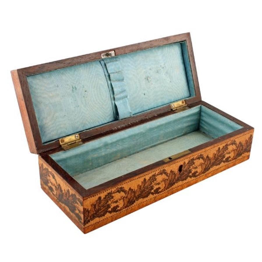 A middle of the 19th century Victorian burr-walnut and Tunbridge inlaid sewing box.

The box has geometric Tunbridge ware inlays to the lid and Tunbridge scrolling leaves around the sides.

The interior of the box has a light blue material