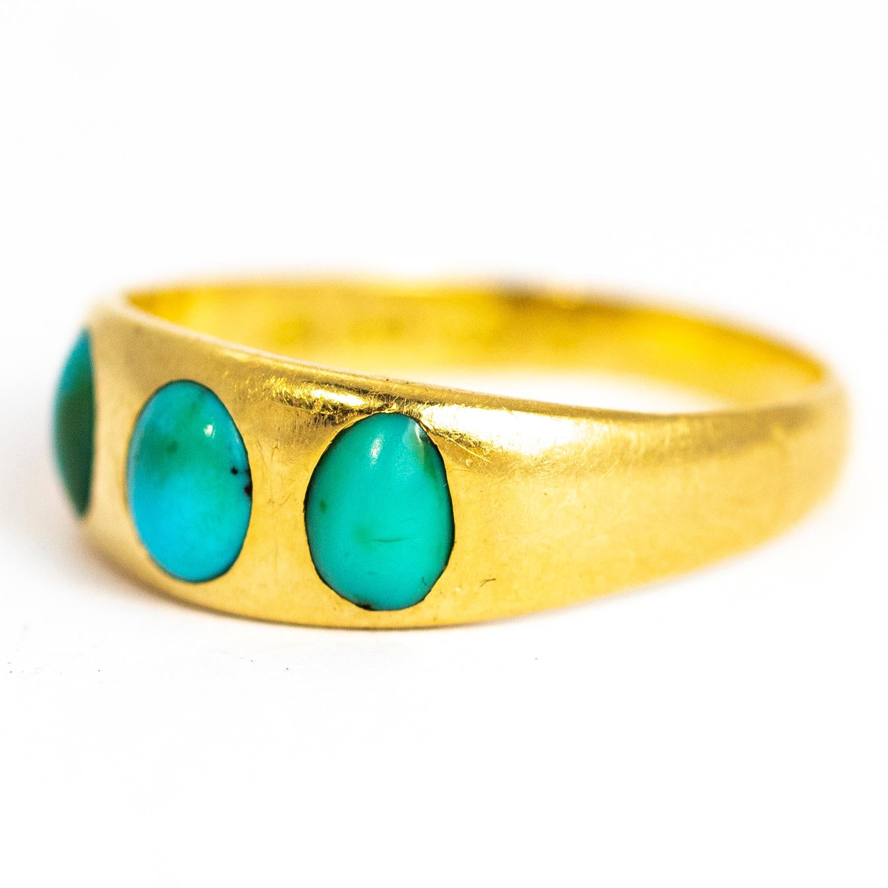 Classic three stone turquoise and gold band. The three turquoise stones are nice and bright blue and set flush within the glossy 18ct gold band. Made in Birmingham, England.

Ring Size: S or 9
Band Width: 7mm