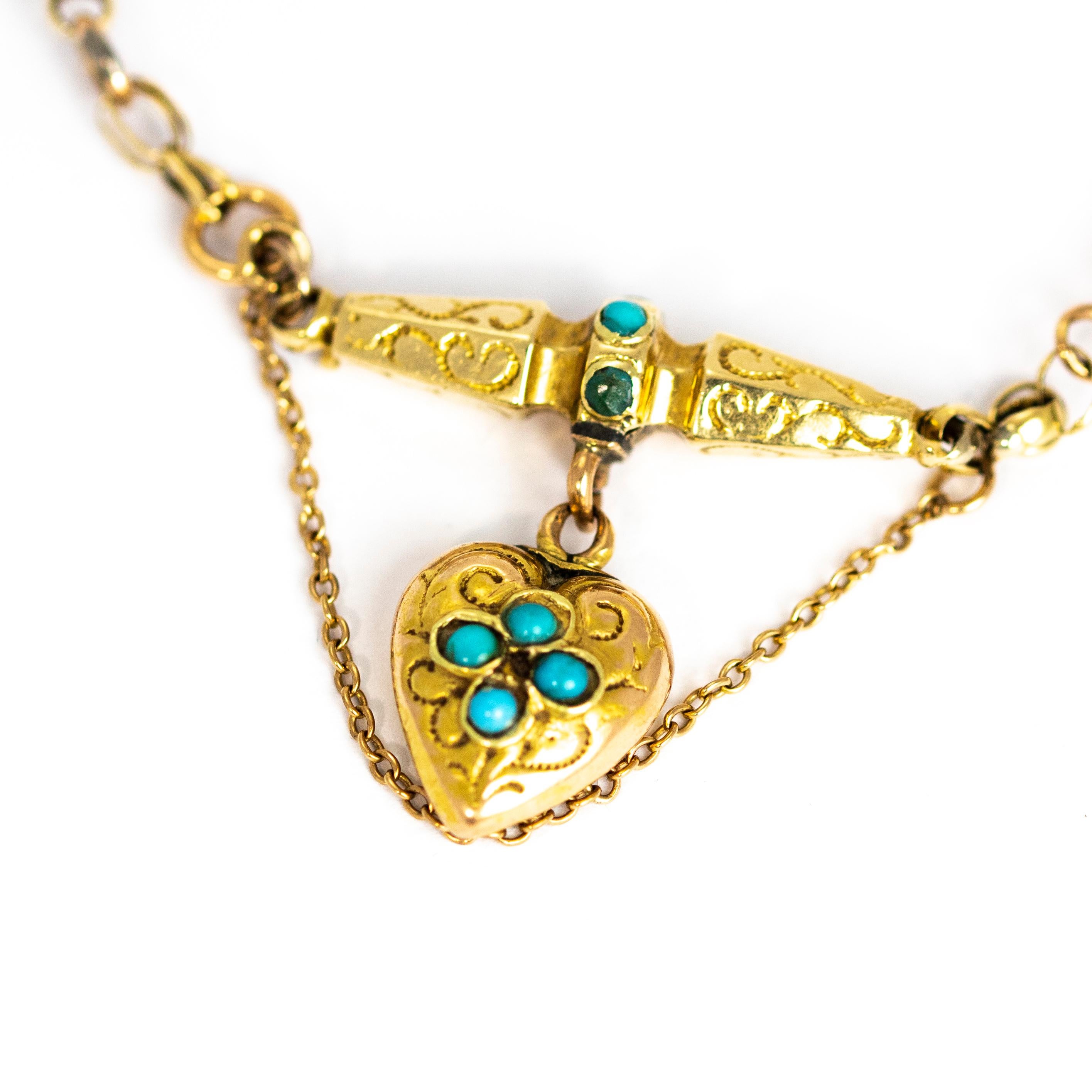 This charming heart pendant bracelet is full of detail. The large decorative links are delicately engraved and the main attraction is the heart pendant that hangs from one of these links. The heart id decorated with turquoise stones and more