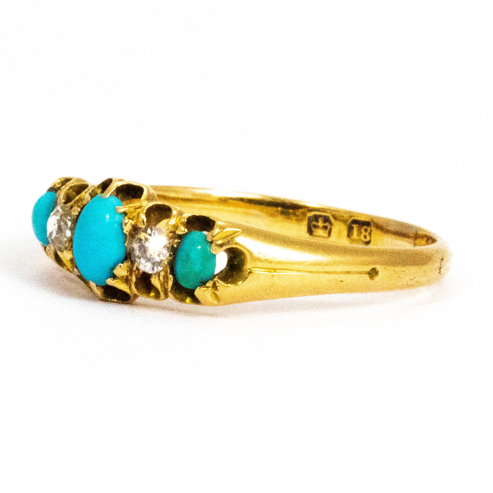 This gorgeous victorian three stone holds a trio of oval bright blue turquoise stones and in between them sit a bright, round sparkling diamond. The stones are enclosed in curls of bright 18ct yellow gold which then carried down with engraved line