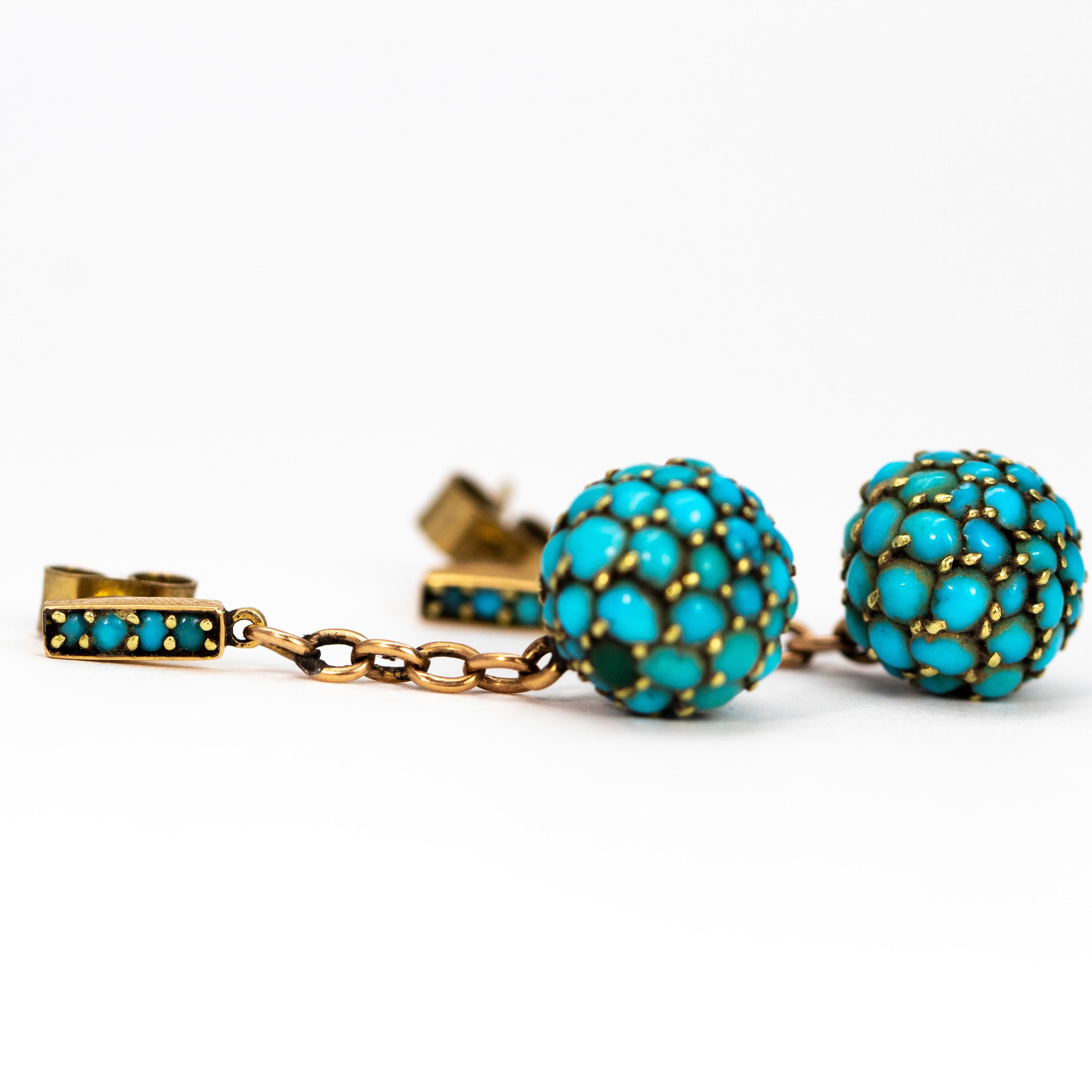 Adorned with turquoise the two orbs on the end of two delicate chains hang freely and add a pop of colour to any outfit! The stud part f the earring is made up of a rectangular paned holding four small turquoise stones. 

Drop From Ear: 33mm
Orb