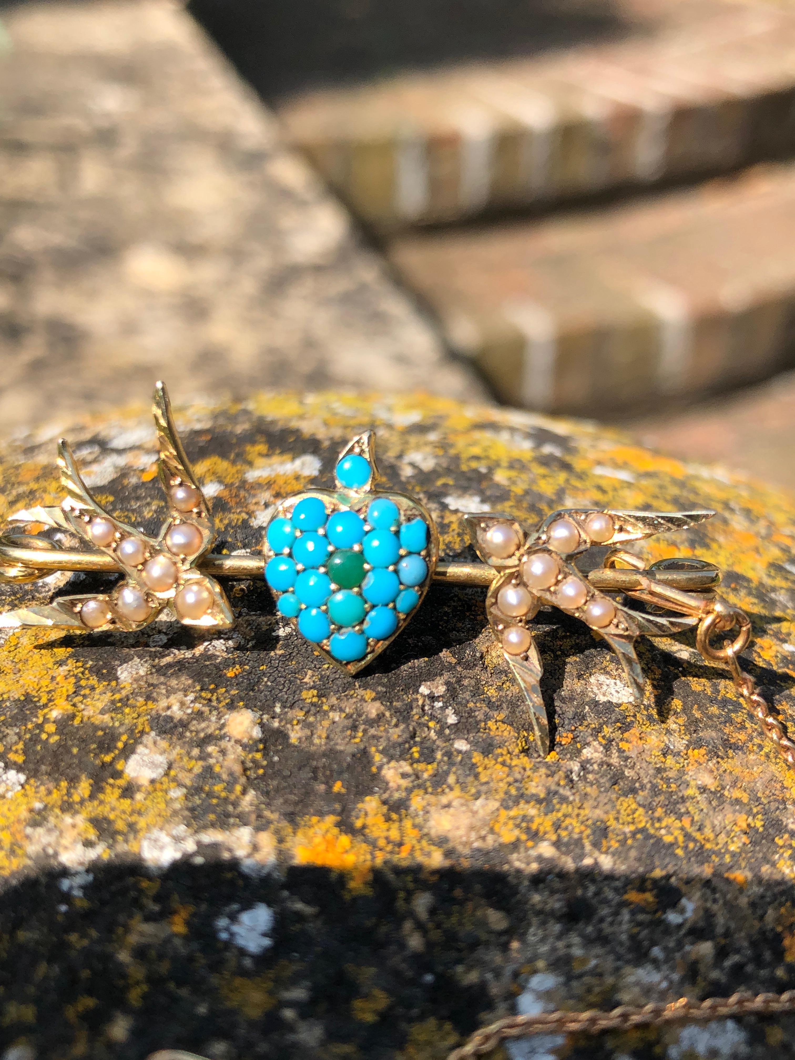 The two love birds on this brooch appear to be sweet swallows set with gorgeous seed pearls. The heart that sits between them is adorned with bright turquoise stones which pop next to the 15ct yellow gold and pearls.

Length Longest Side: