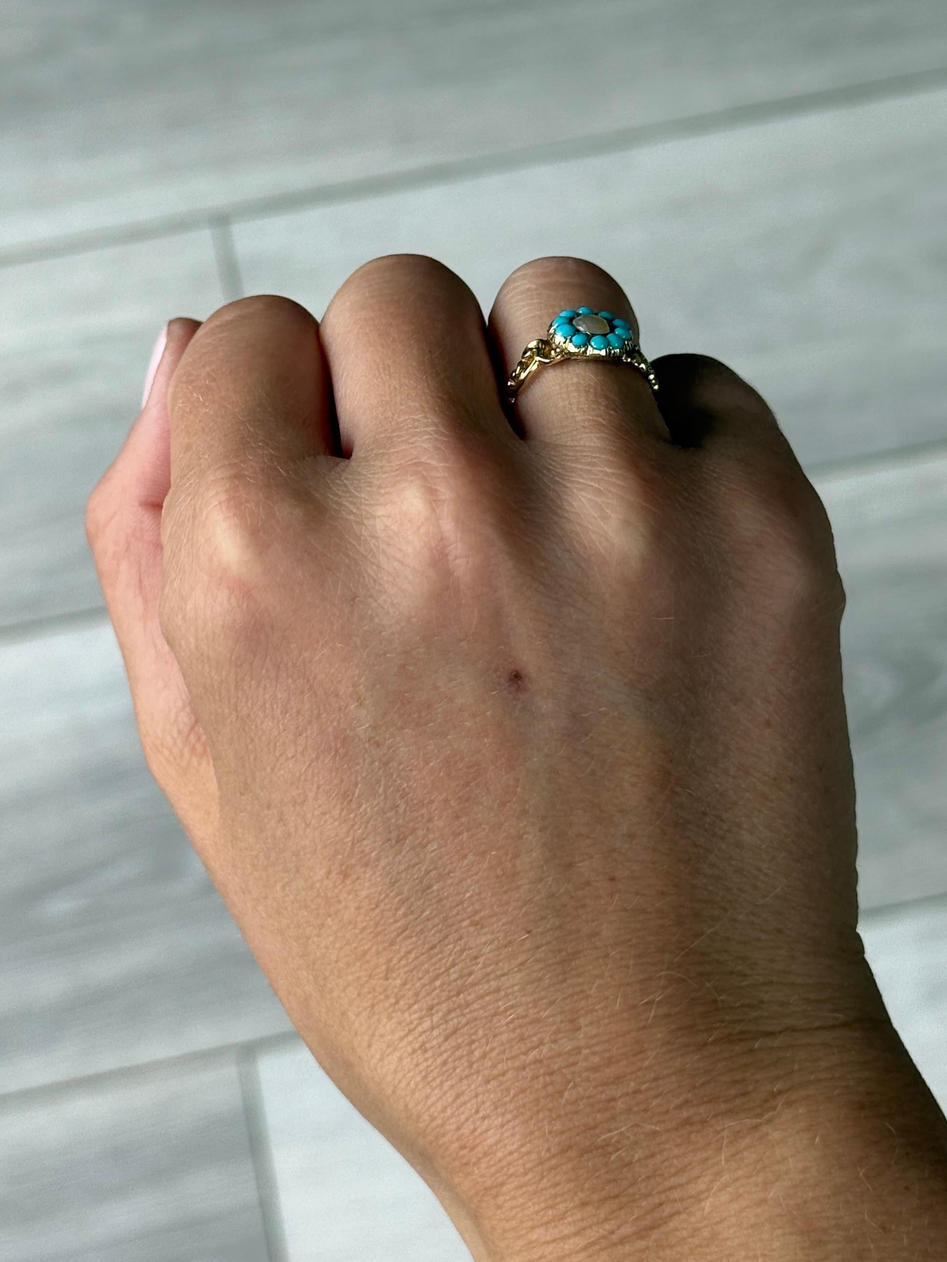 Questo delizioso anello a grappolo contiene dieci turchesi brillanti e al centro si trova una perla. L'anello è modellato in oro 9ct e ha delle bellissime spalle. 

Misura dell'anello: J o 4 3/4
Diametro del cluster: 10x9,5 mm
Altezza dal dito: 2,5